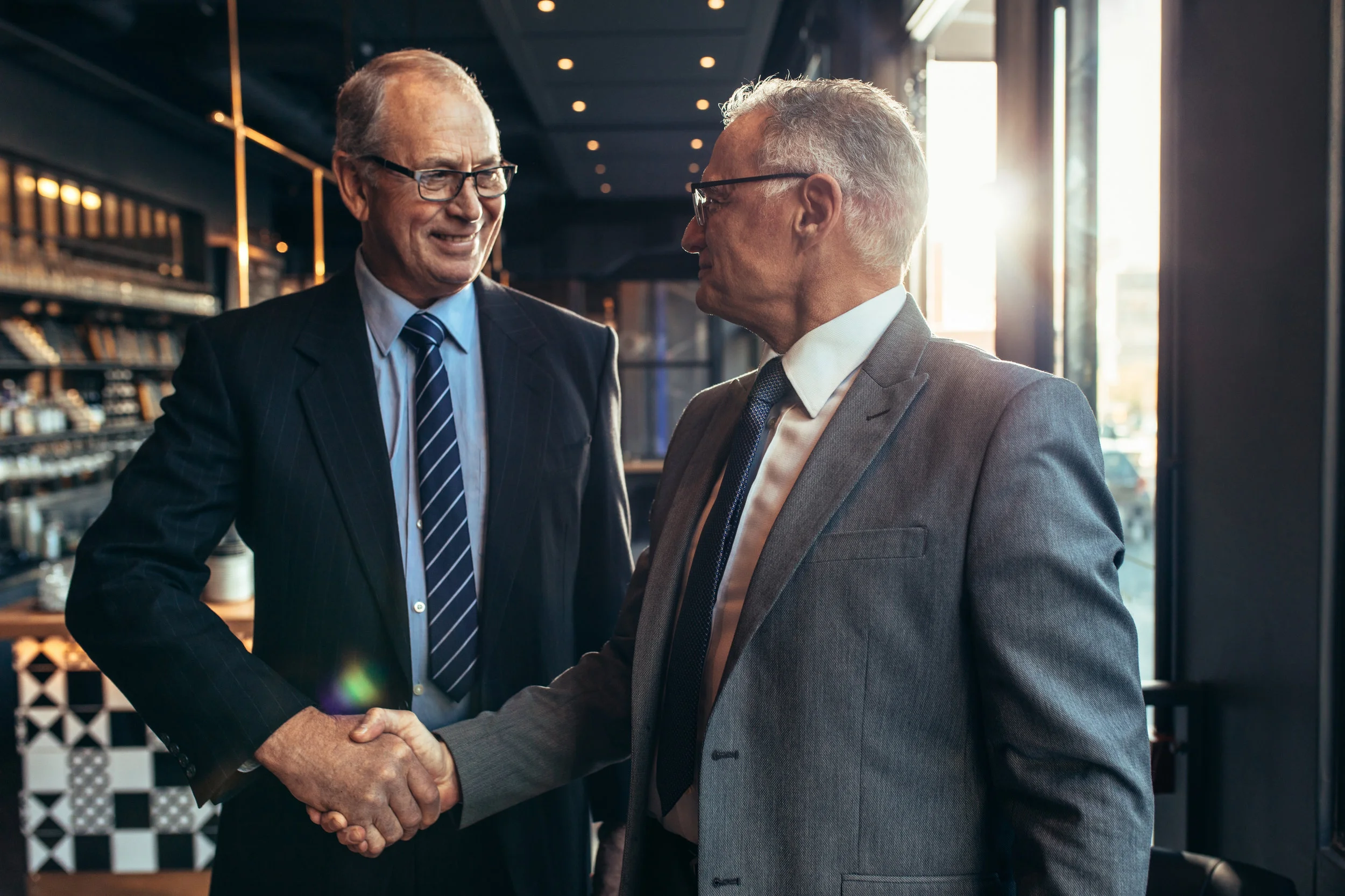 Canva - Business Partners Handshake at Cafe.jpg