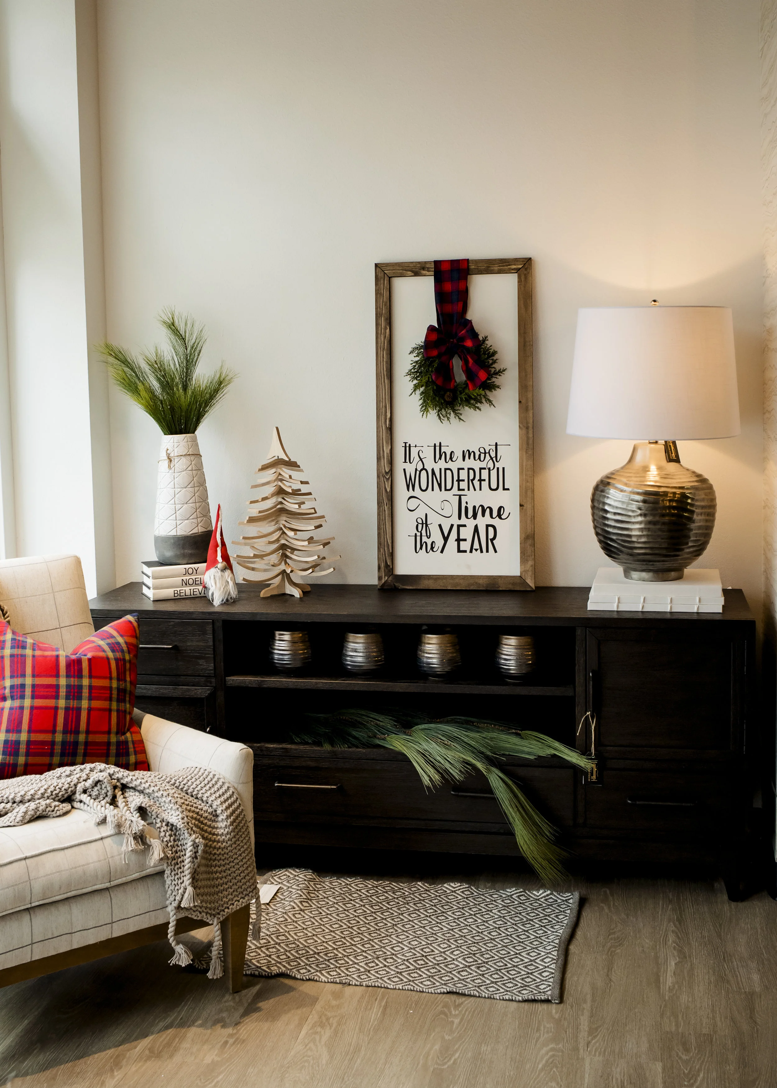 Swivel Tree $34, Santa Gnome $13, Harrier Gray Vase $75, Pine Spray $7.50, Joy/Noel/Believe Books $37/ec, Long Needles Pine Hanging $44, Accent Rug $56, Gray Organic Cotton Throw $145, Plaid Pillow $41.50, Make & Take Wonder Sign $65, Pots $14.50/ec