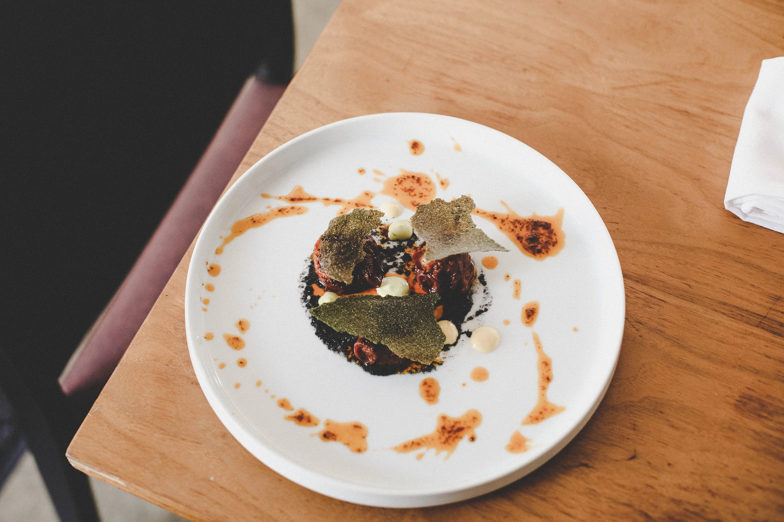 Chorizo octopus with burnt onion pure, chilli sauce, and cassava crackers.