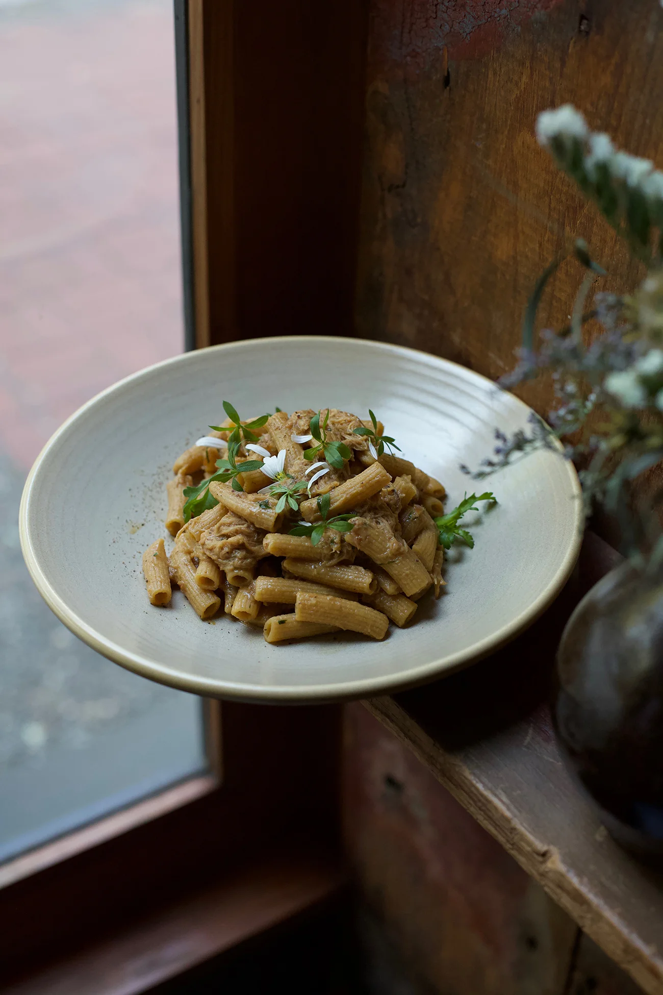 Rabbit Ragu, housemade rigatoni, foraged lovage herb leaf, and elderflower to top.