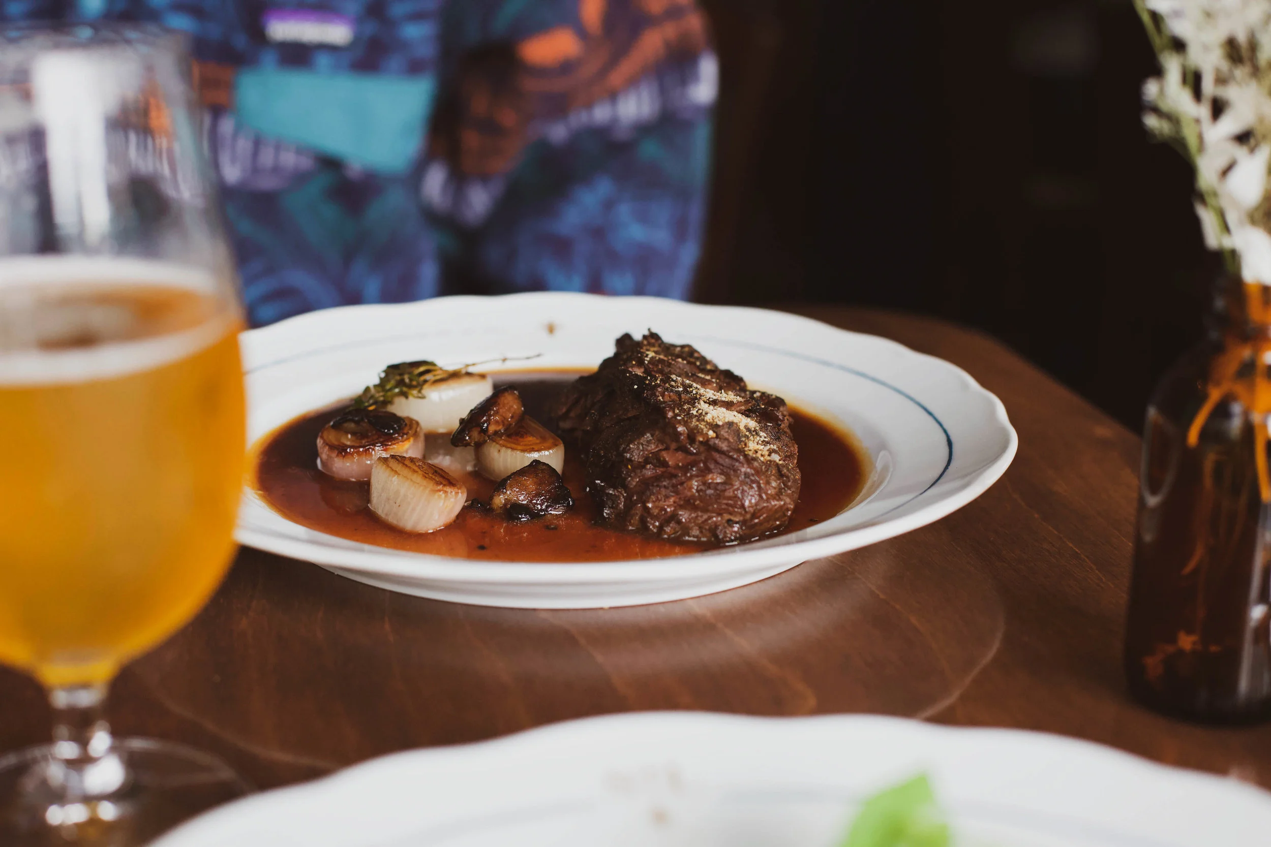 grilled hanger steak, seared onions, bone marrow, and sauce aux poivres