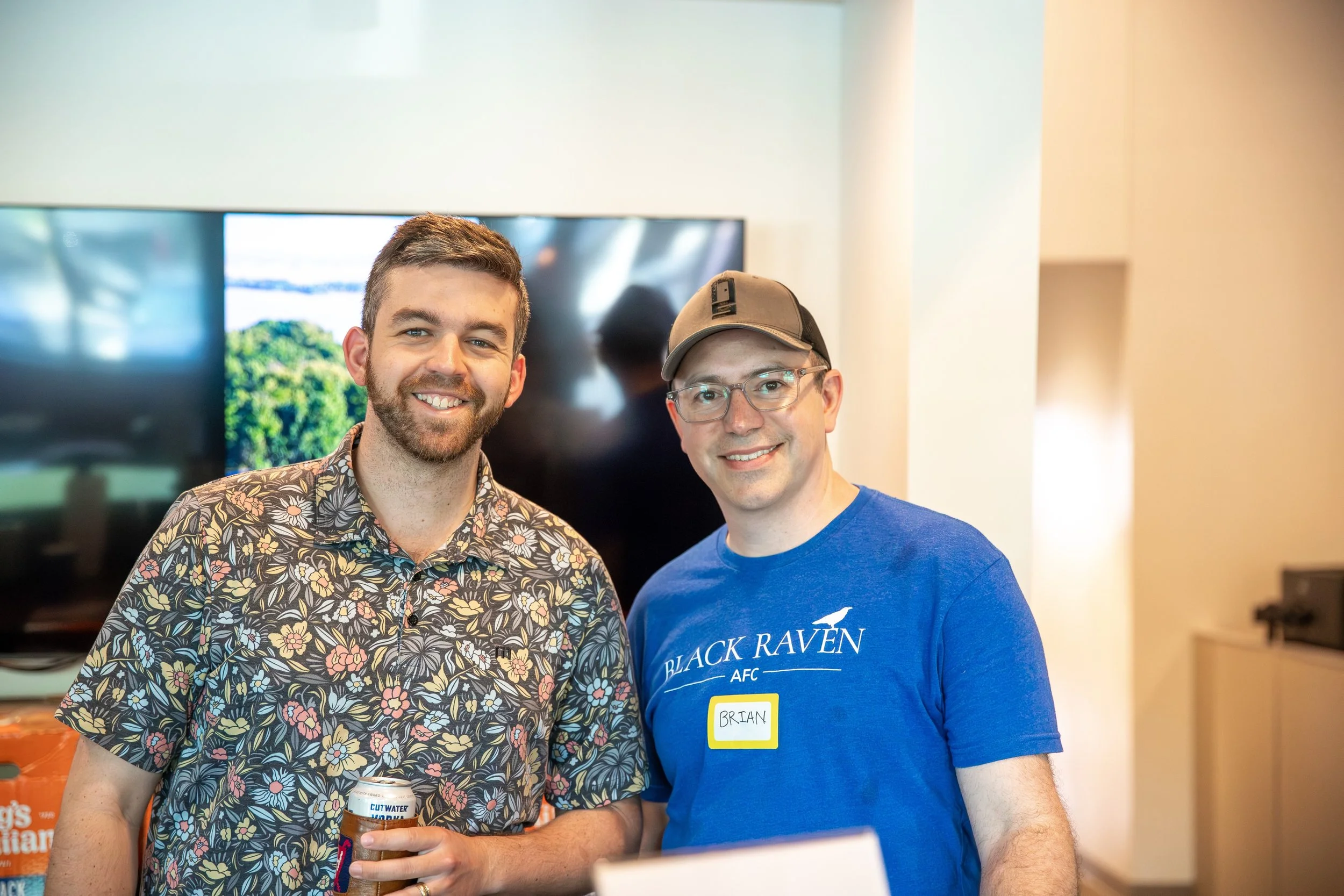 two men smiling while posing for a photo at thrive coworking space