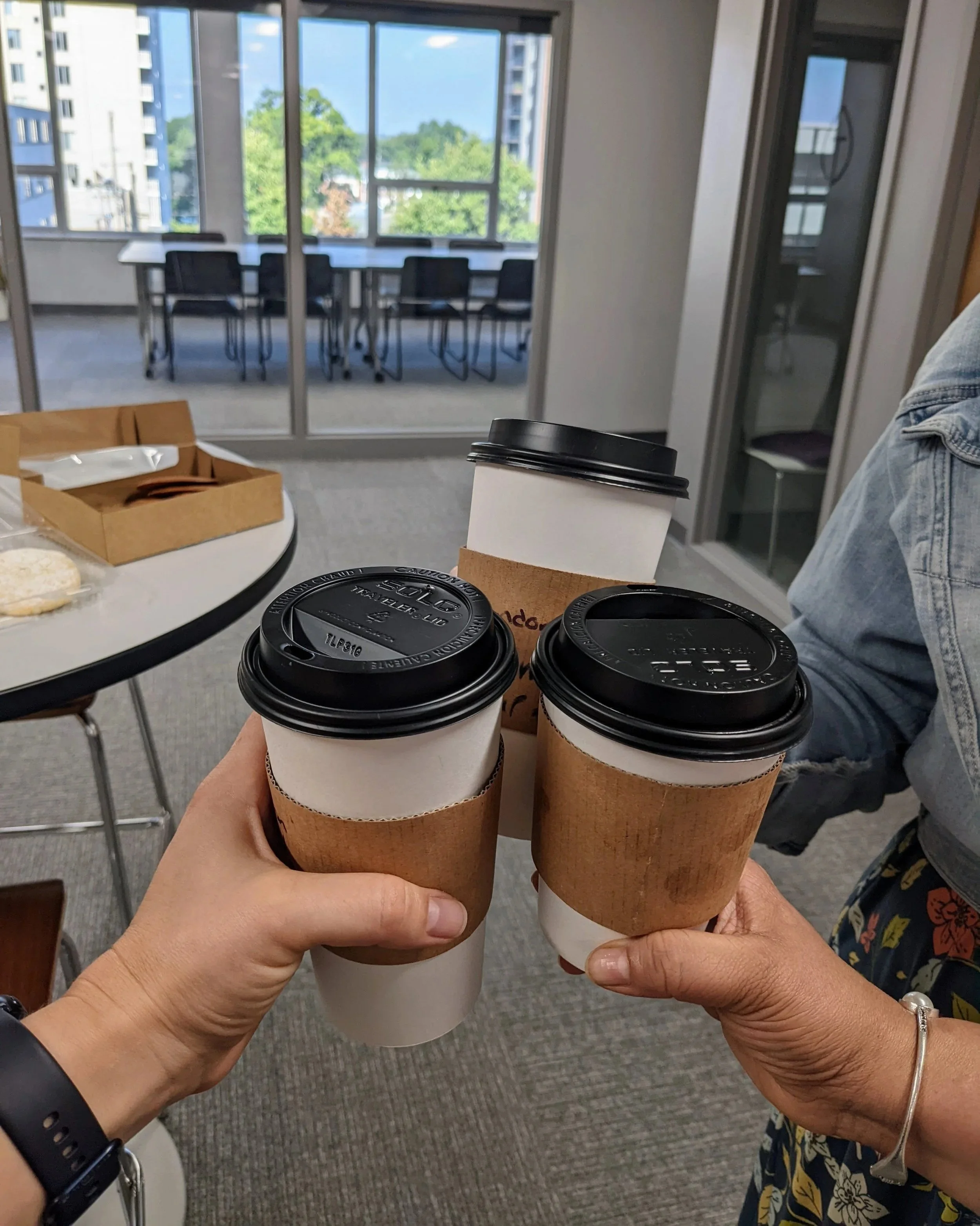 coworkers sharing coffee at ThriveCo's coworking space in Clayton