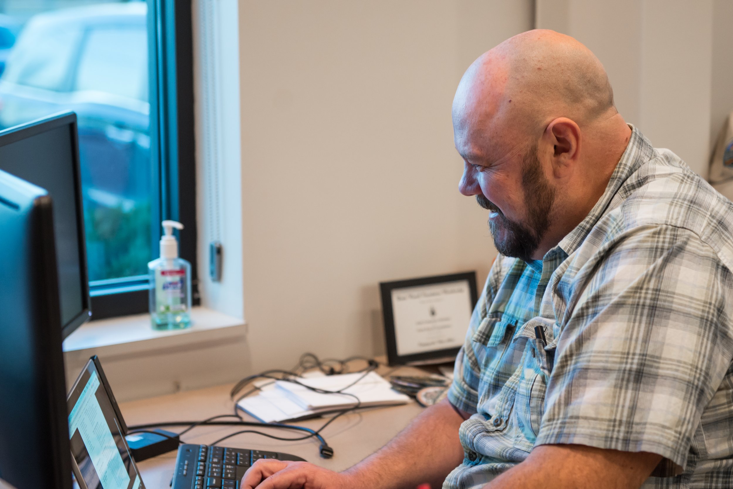 A man sitting in a coworking space working on a laptop