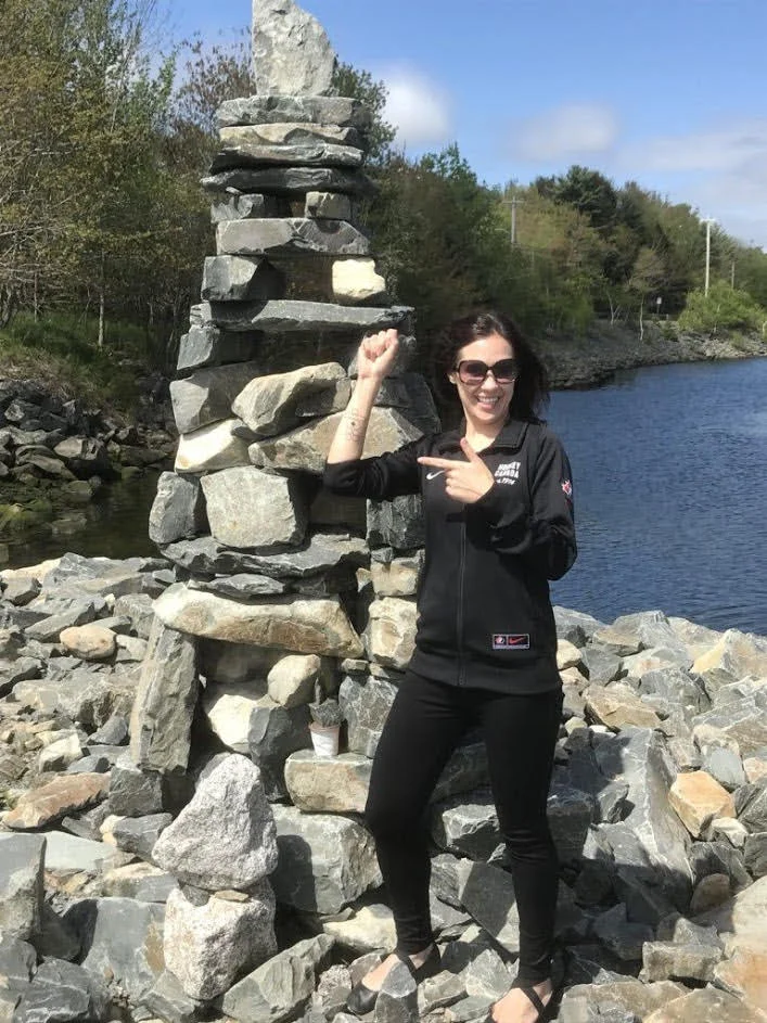 Shannon standing in front of an “inukshuk” in Nova Scotia – an Inuit totem that means "to guide on a safe journey," or "to guide someone peacefully and on a safe journey." And, yes, she is showing off a tattoo modeled after the totem. “I loved the meaning behind it.” As we listen to her story, we understand why.