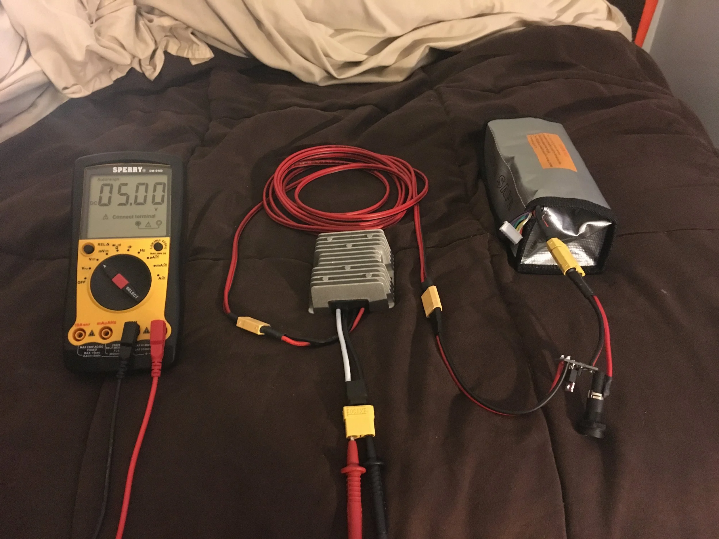 Here's the power system all wired up and showing a steady 5V! Note that I got a LiPo safe so that should something go terribly wrong, the LiPo fire will be somewhat contained...