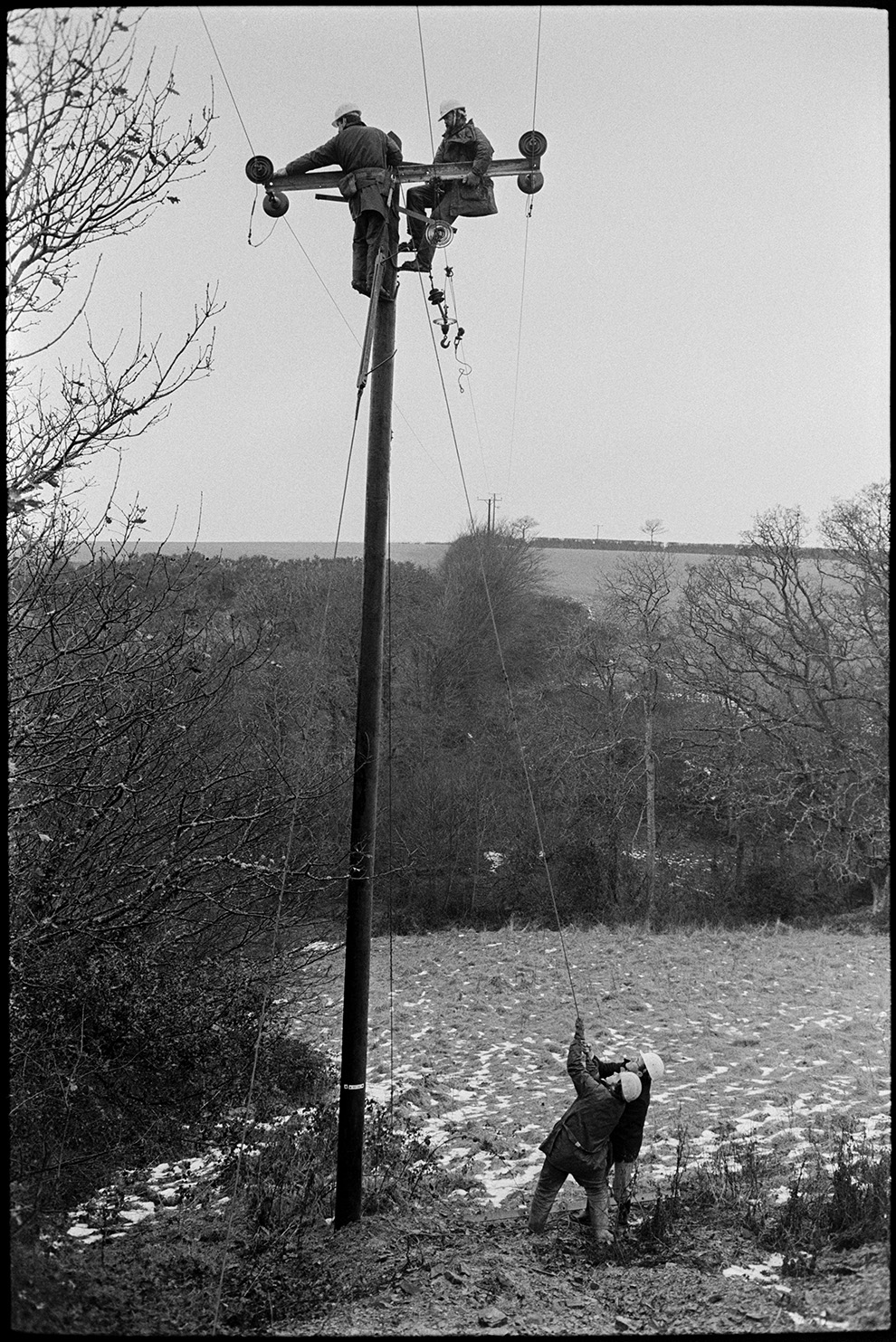 Electricity Board engineers putting up new power cables to village, Dolton,  2 January 1979.