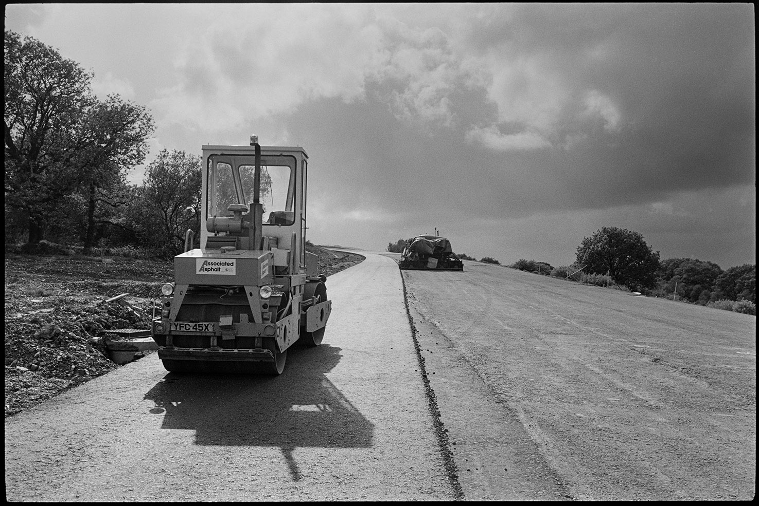Machinery on new motorway link road shortly before it opened, diesel roller & earth mover, near Rackenford, August 1988.