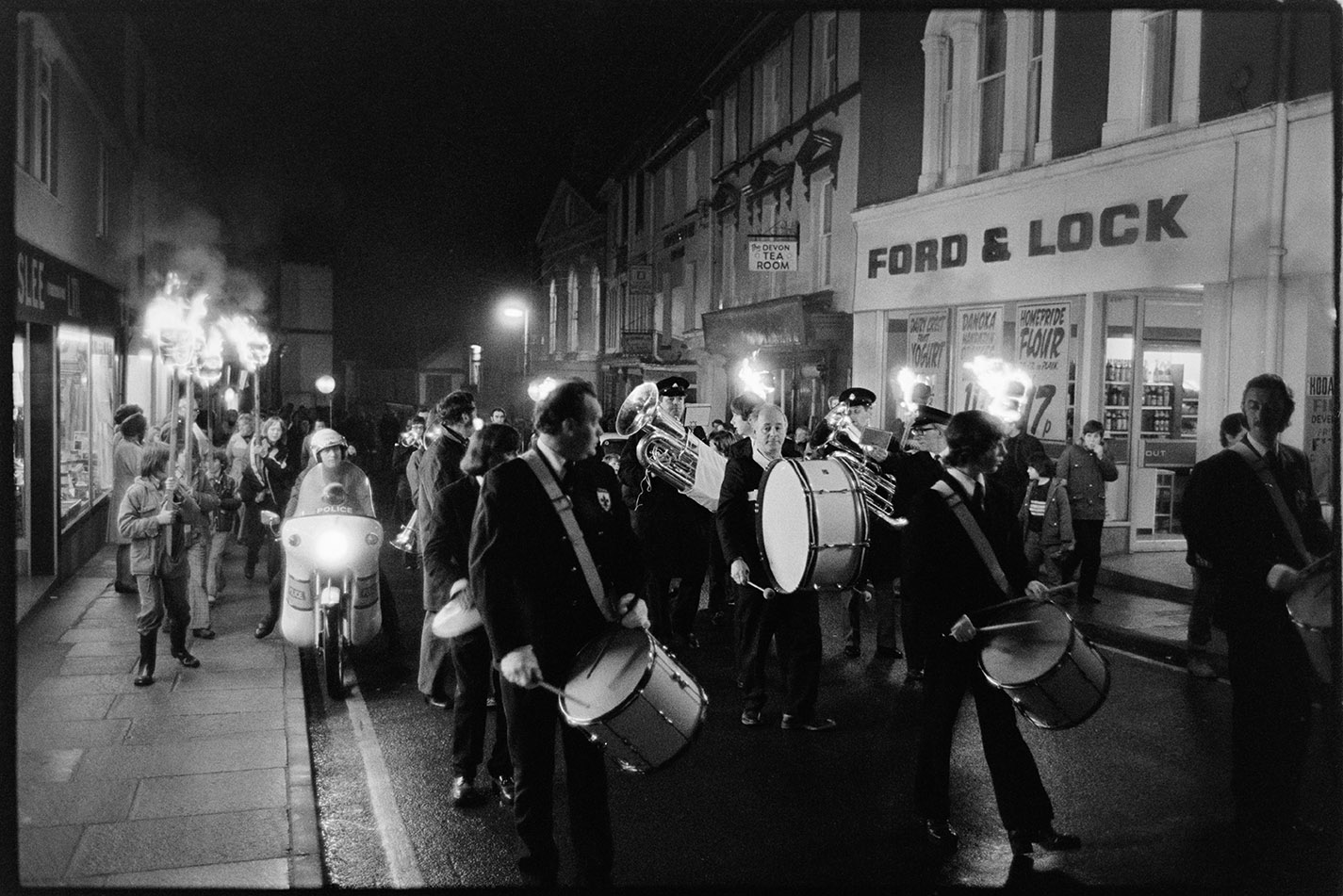 Street scene with torch bearers, Torrington, 2 November 1974