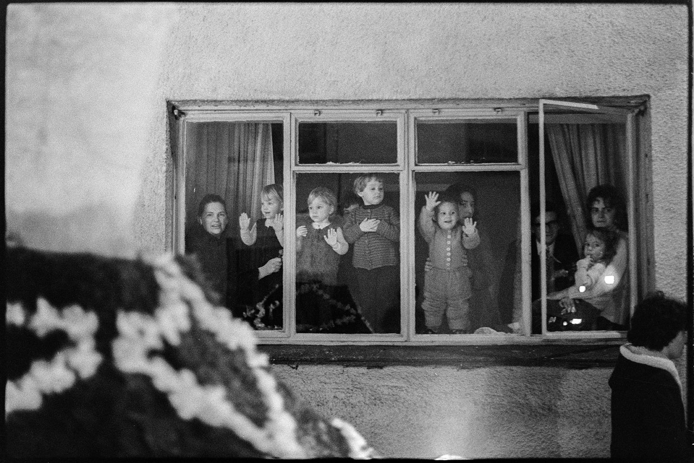 People watching night procession from window, Hatherleigh, 6 November 1974