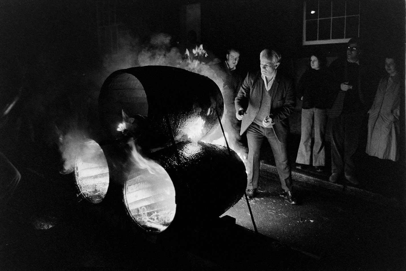 Burning tar barrels being pulled through the street at night, Hatherleigh, 6 November 1974