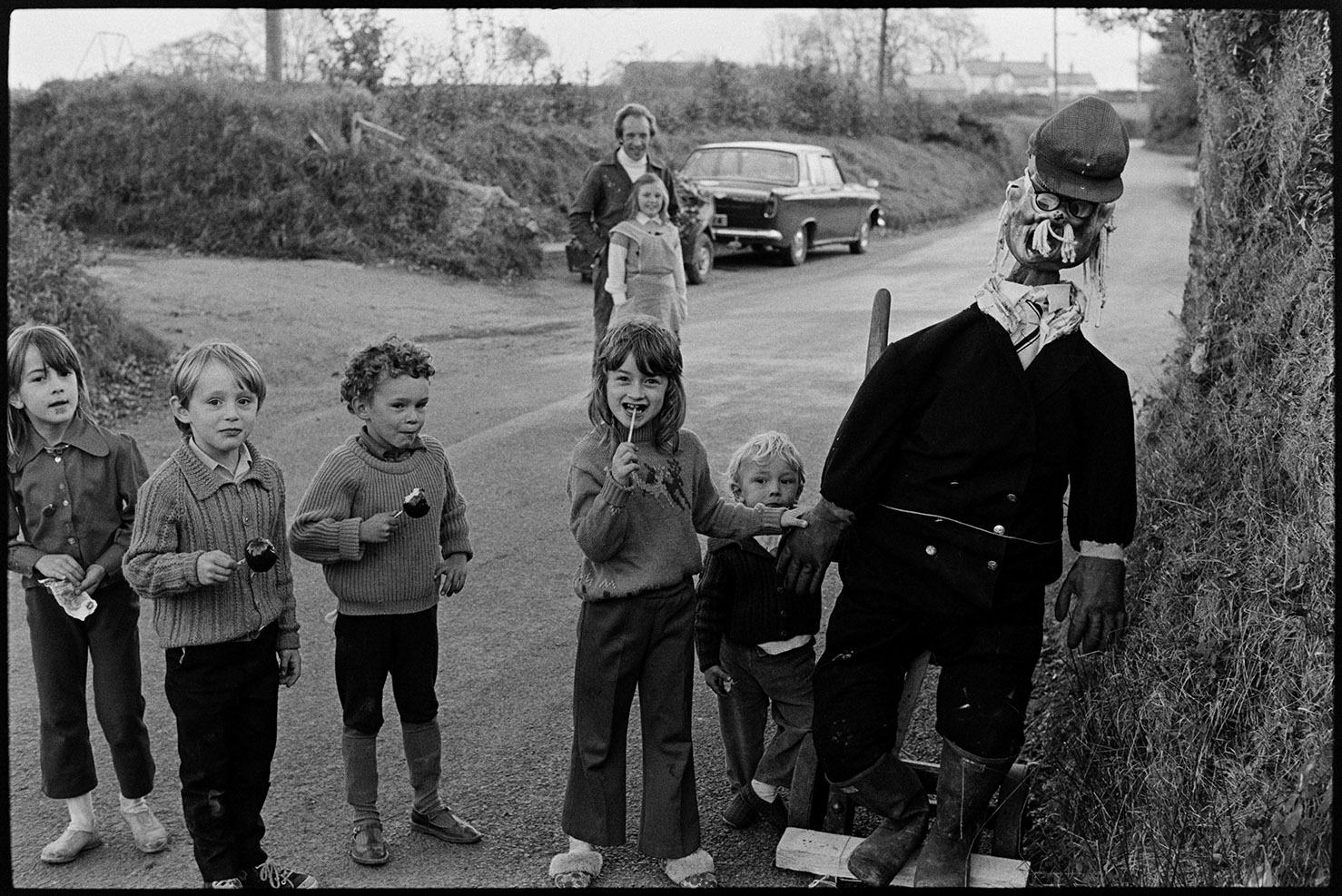 Guy in village street with children - Guy Fawkes, Ashreigney, October 1975