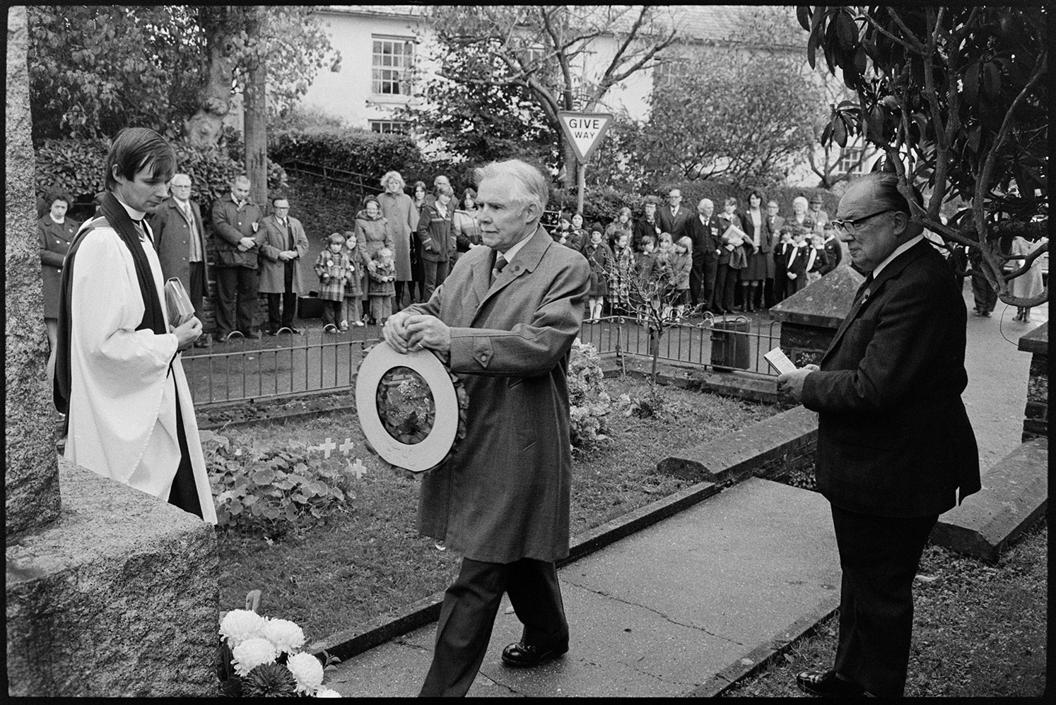 Remembrance Day ceremony at village war memorial, old soldiers with poppy wreath.  Dolton, 11 November 1979