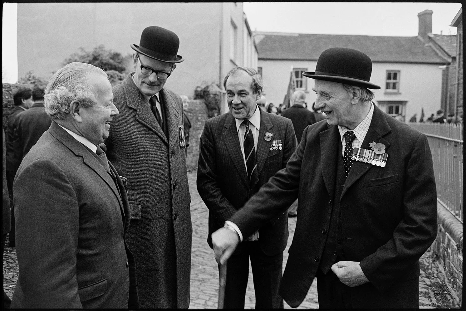 Armistice Day, men chatting after parade, officers in bowler hats. Chulmleigh, November 1981.