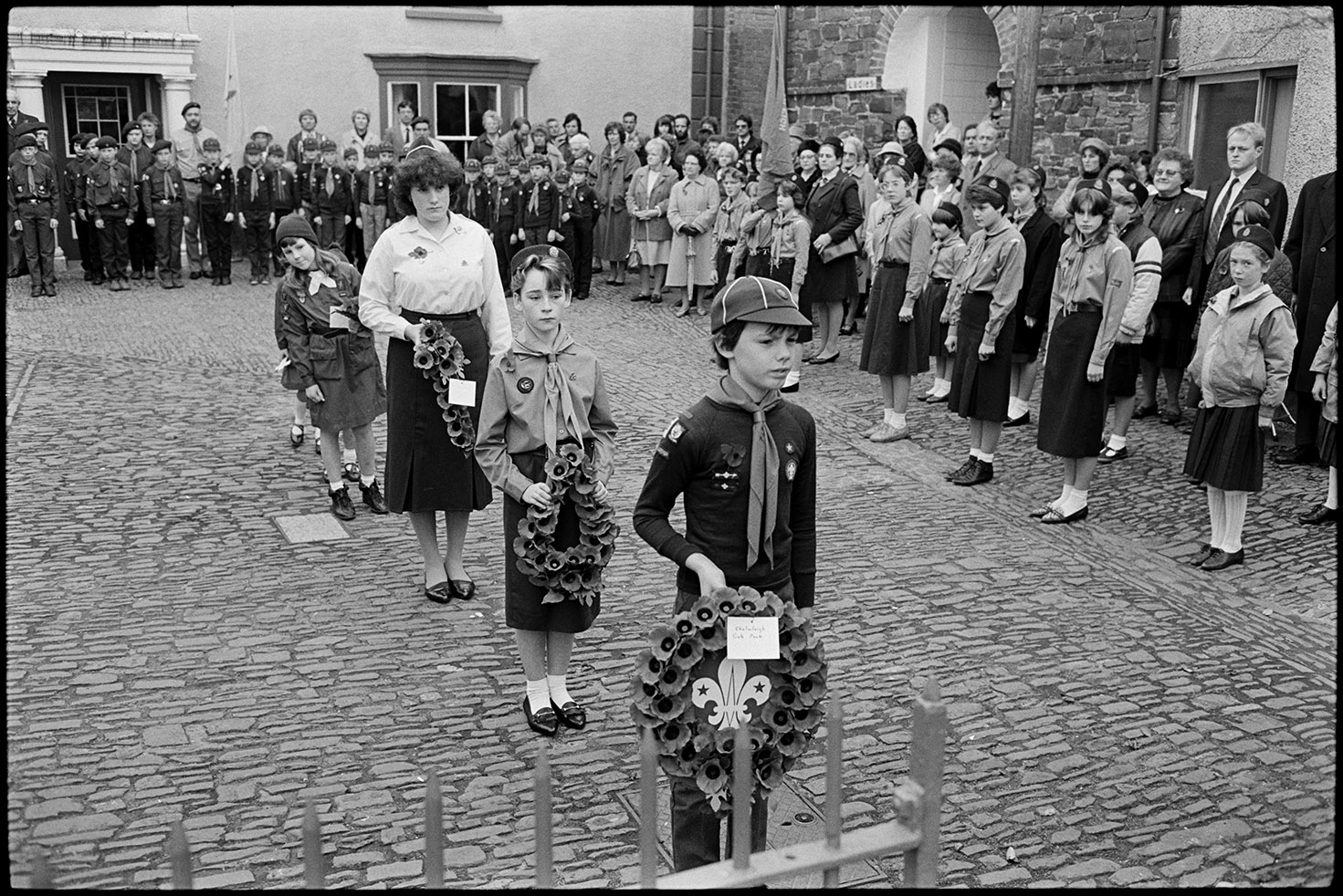 Parade at Memorial, laying wreaths by scouts, brownies &amp; guides.  Chulmleigh, November 1987.