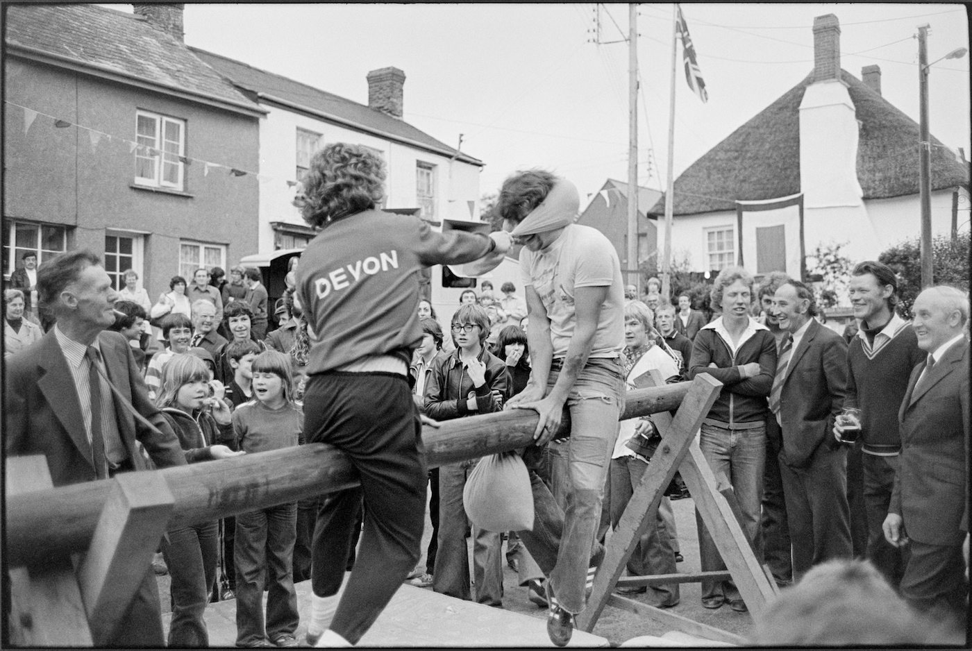 Village fair, pillow fight on greasy pole, Winkleigh, August 1980. Documentary photograph by James Ravilious for the Beaford Archive © Beaford Arts