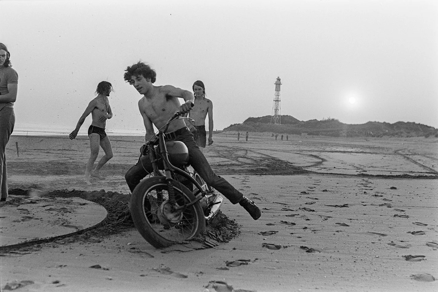 Lads on motorbike on beach. Documentary photograph by Roger Deakins for the Beaford Archive © Beaford Arts