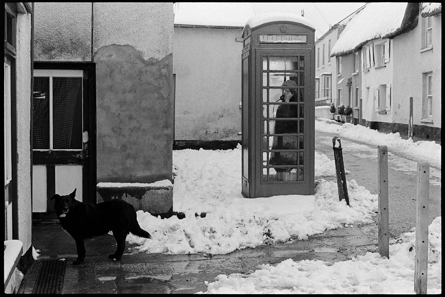 Woman in phone box, talking on phone, Dolton, January, 1979. Documentary photograph by James Ravilious for the Beaford Archive © Beaford Arts