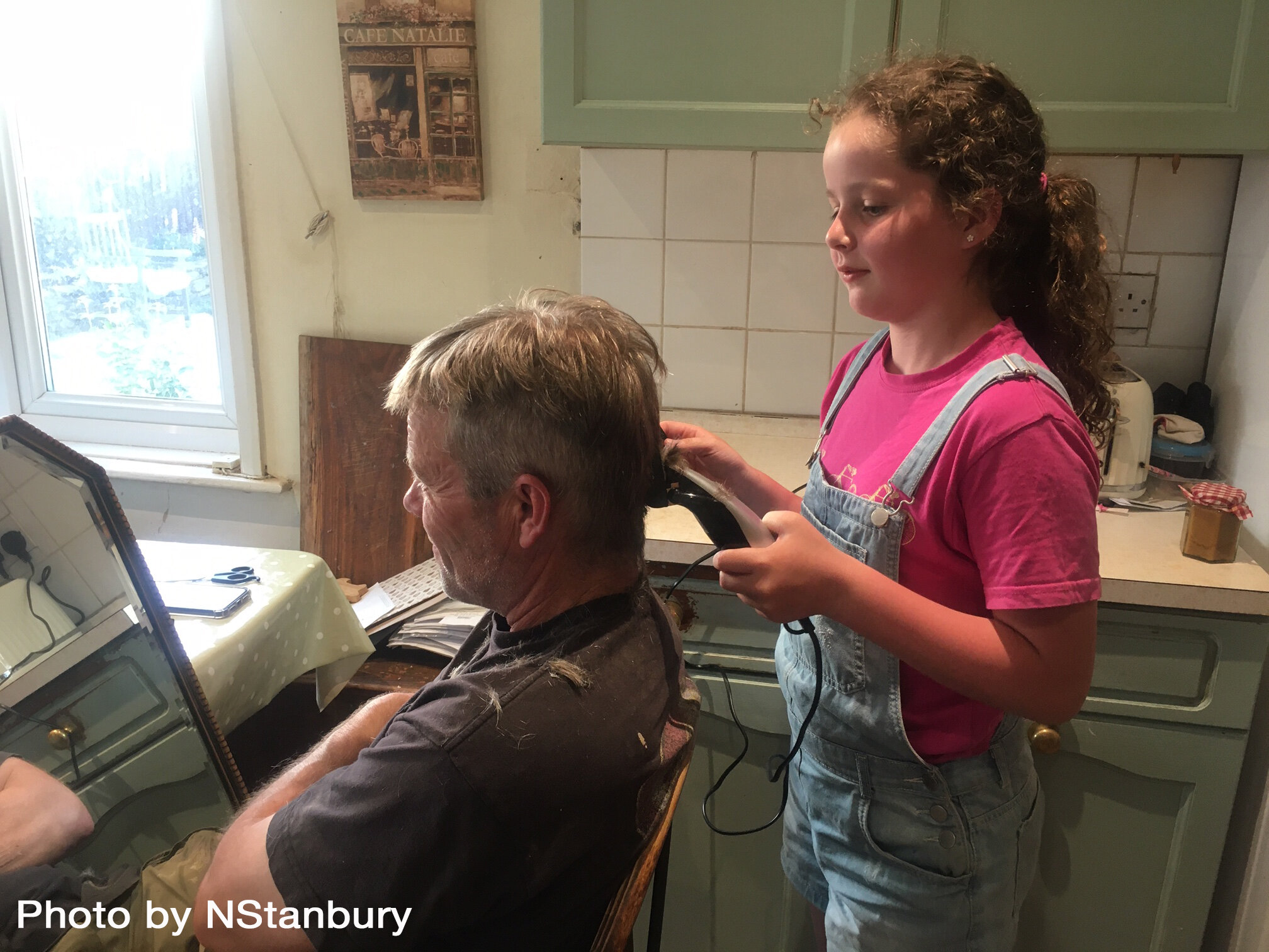 NStanbury Girl cutting man's hair Berrynarbor 270520.jpg