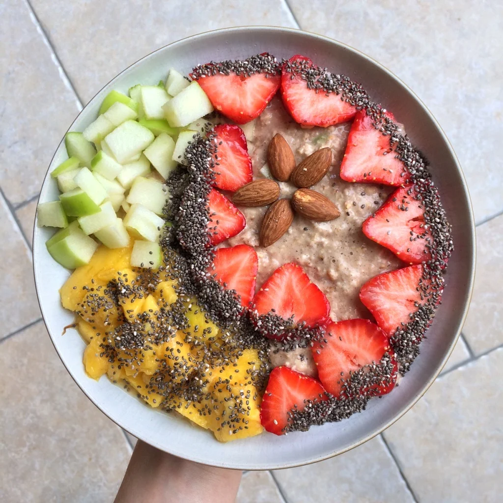 Cinnamon-spiced oatmeal topped with strawberry hearts, diced Granny Smith apple, mango, whole almonds and chia seeds. 