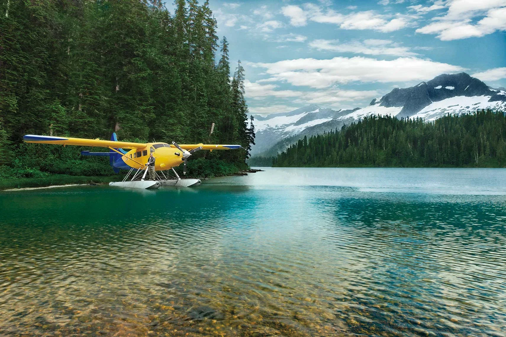 ellow floatplane carrying explorer Sebastian Copeland on a remote lake in British Columbia.