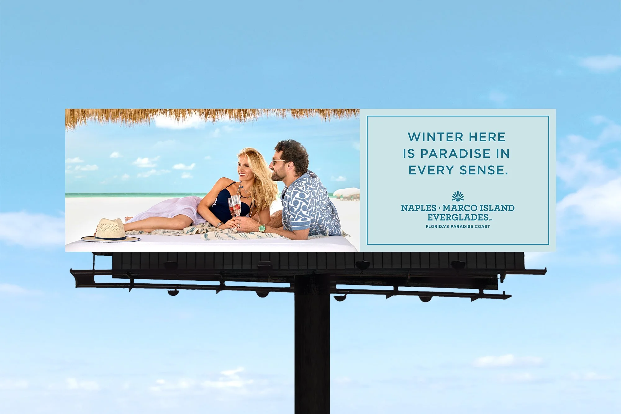 Tourism billboard for Florida’s Paradise Coast featuring luxury beach lifestyle couple promoting Naples Marco Island Everglades photographed by George Kamper.