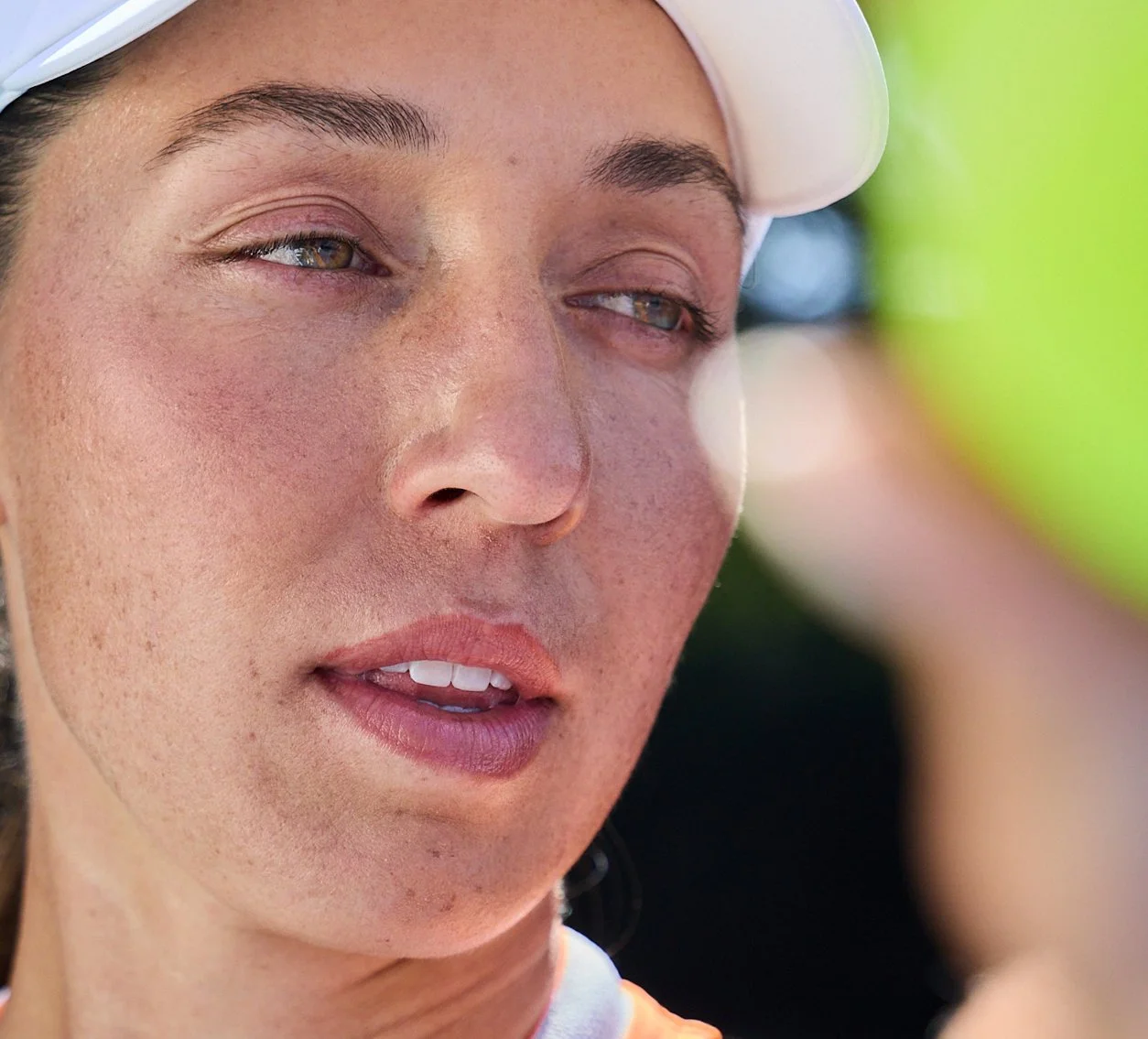 Close-up of Jessica Pegula gripping a tennis ball before serve during campaign