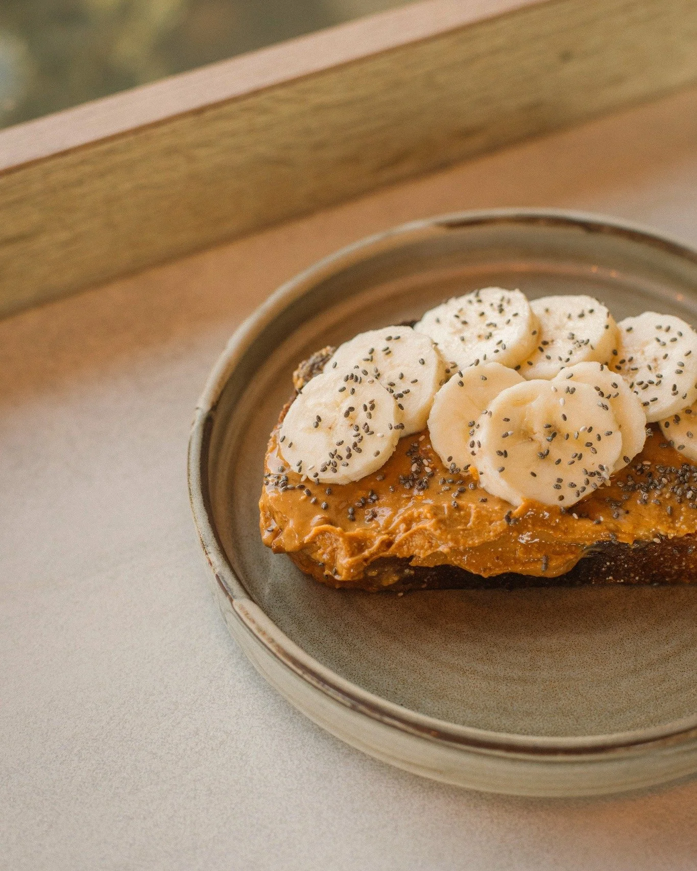 Peanut butter &amp; banana on toast 🍌🥜✨

Toasted sourdough topped with deep roasted peanut butter, sliced banana, and chia seeds - the perfect energy boost, done right.

Vegan and gluten-free options available. 

#PeanutButterBanana #OnToast #TheWo