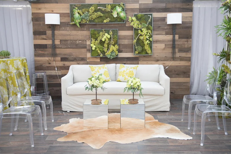 wood portable wall, sconce lamps on wall, cowhide rug, mirror cube side tables