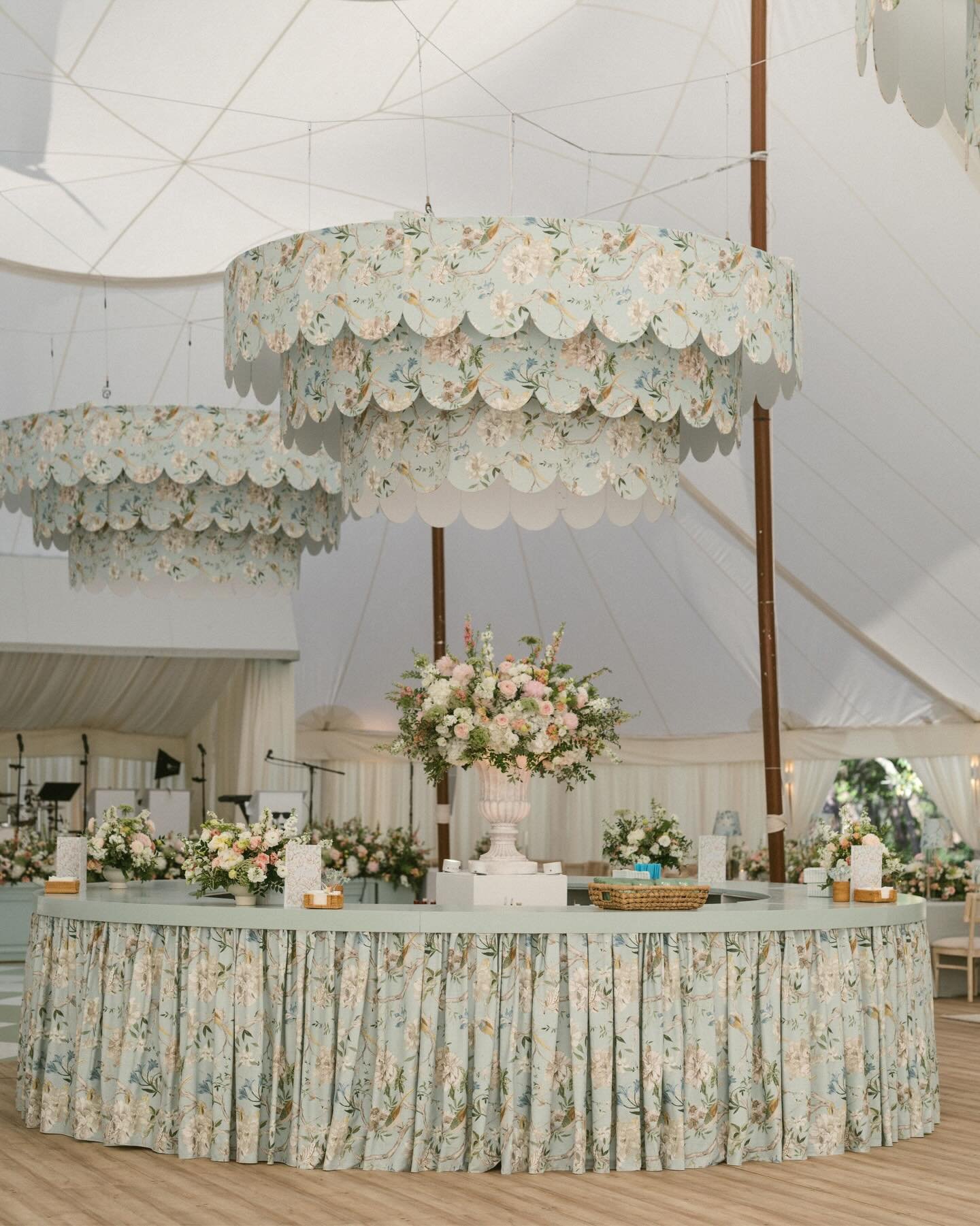 April 18, 2026 | Watercolor, FL

Kyleigh and Ben&rsquo;s sailcloth tent wedding was truly one of a kind. We custom-built three-ring chandeliers wrapped in light blue Eliana Serenity fabric with scalloped edges, layered over our Reina chandelier to cr