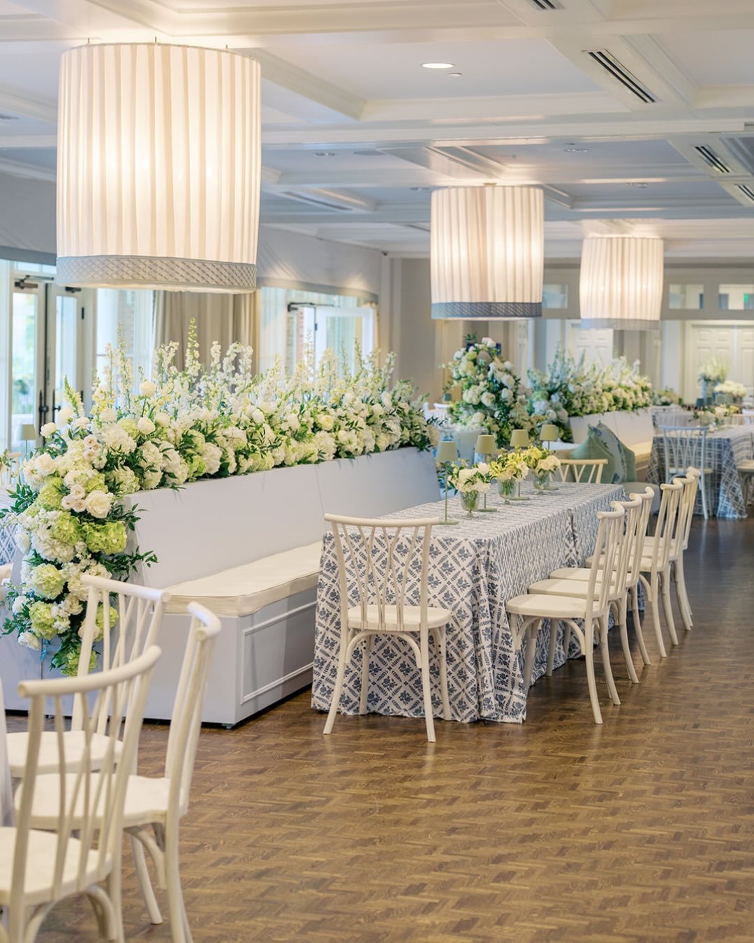 April 2026 | Country Club of Little Rock

Custom six-foot trellis bars and coordinating ten-foot bar backs with arched shelving created elevated focal points throughout the space, while round drum chandelier covers in ivory voile with Sirmione trim s