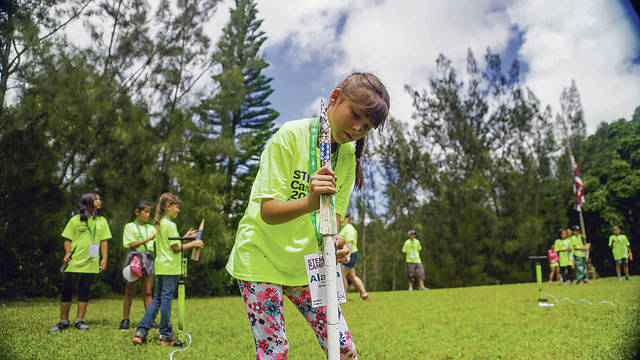COURTESY GIRLS SCOUTS OF HAWAII A Girl Scout named Alana, above, prepared Saturday to launch the rocket she made at STEM Camp at Camp Paumalu on the North Shore.