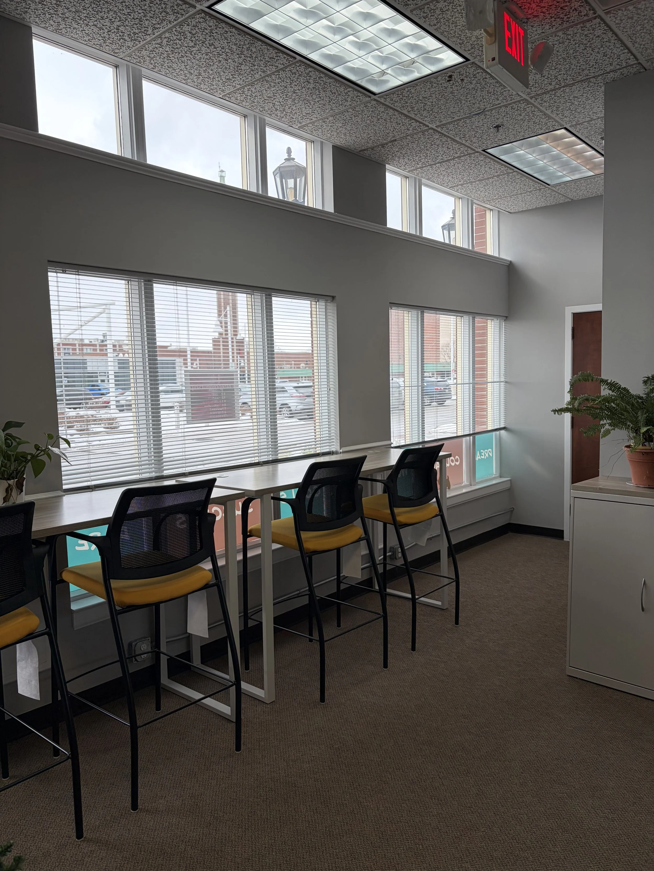 Shared coworking space with desks and large windows at Propeller