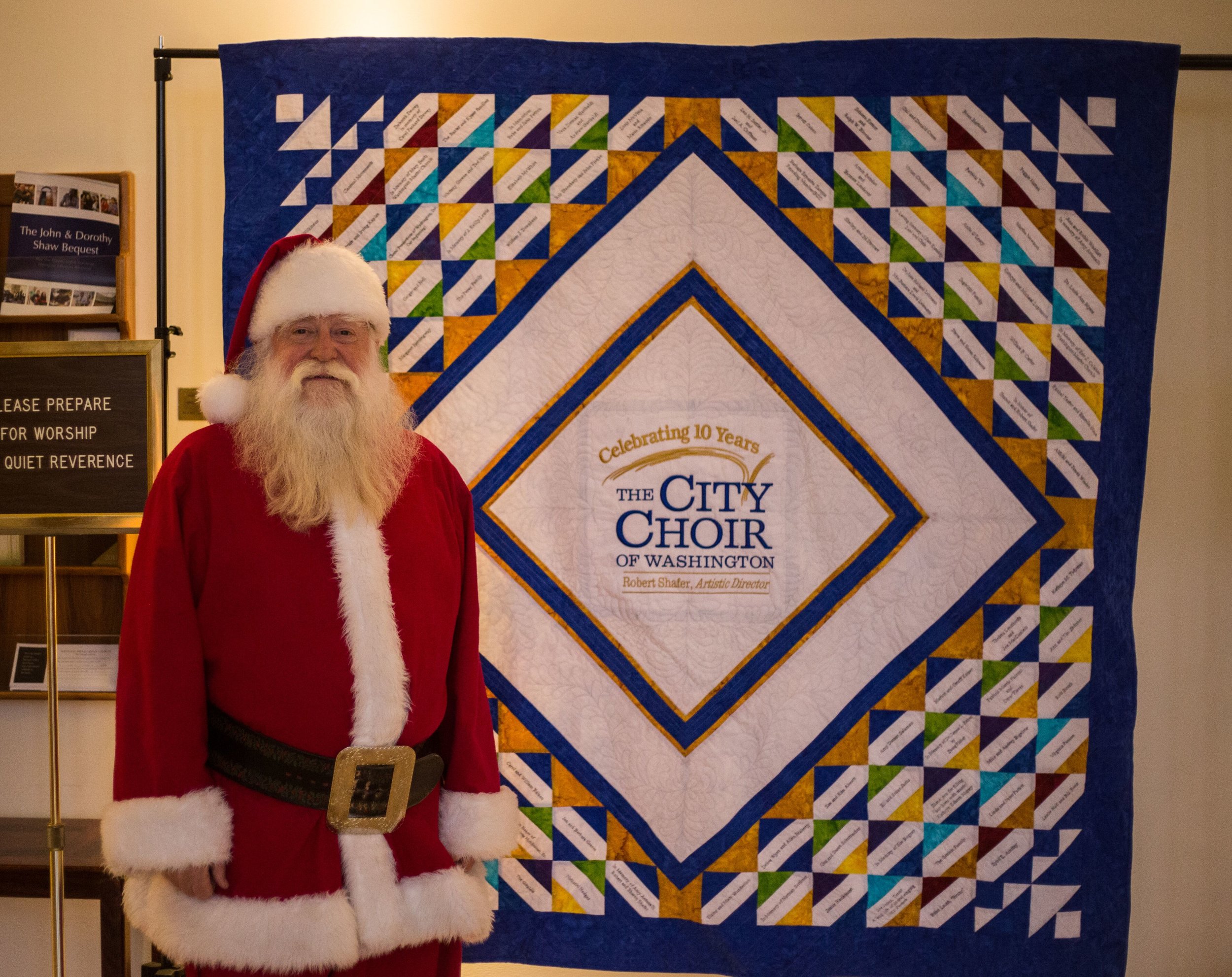 December 2018, "Santa" Steve Schuers with the City Choir 10th Anniversary quilt