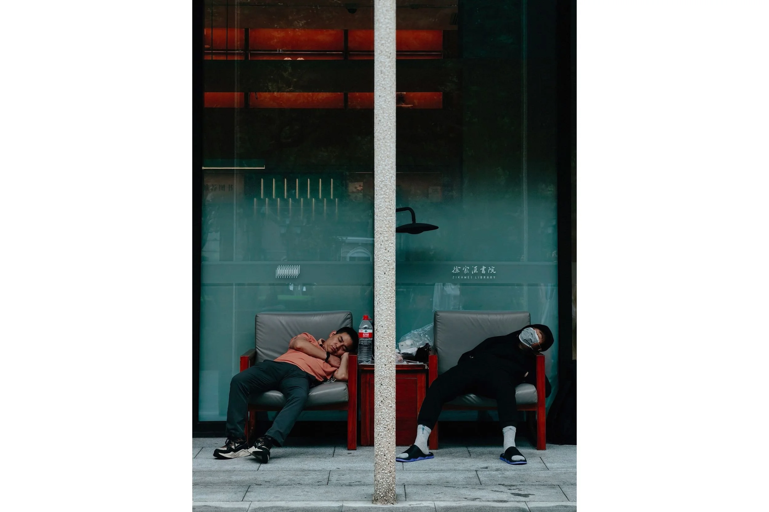 Men sleeping outside the library