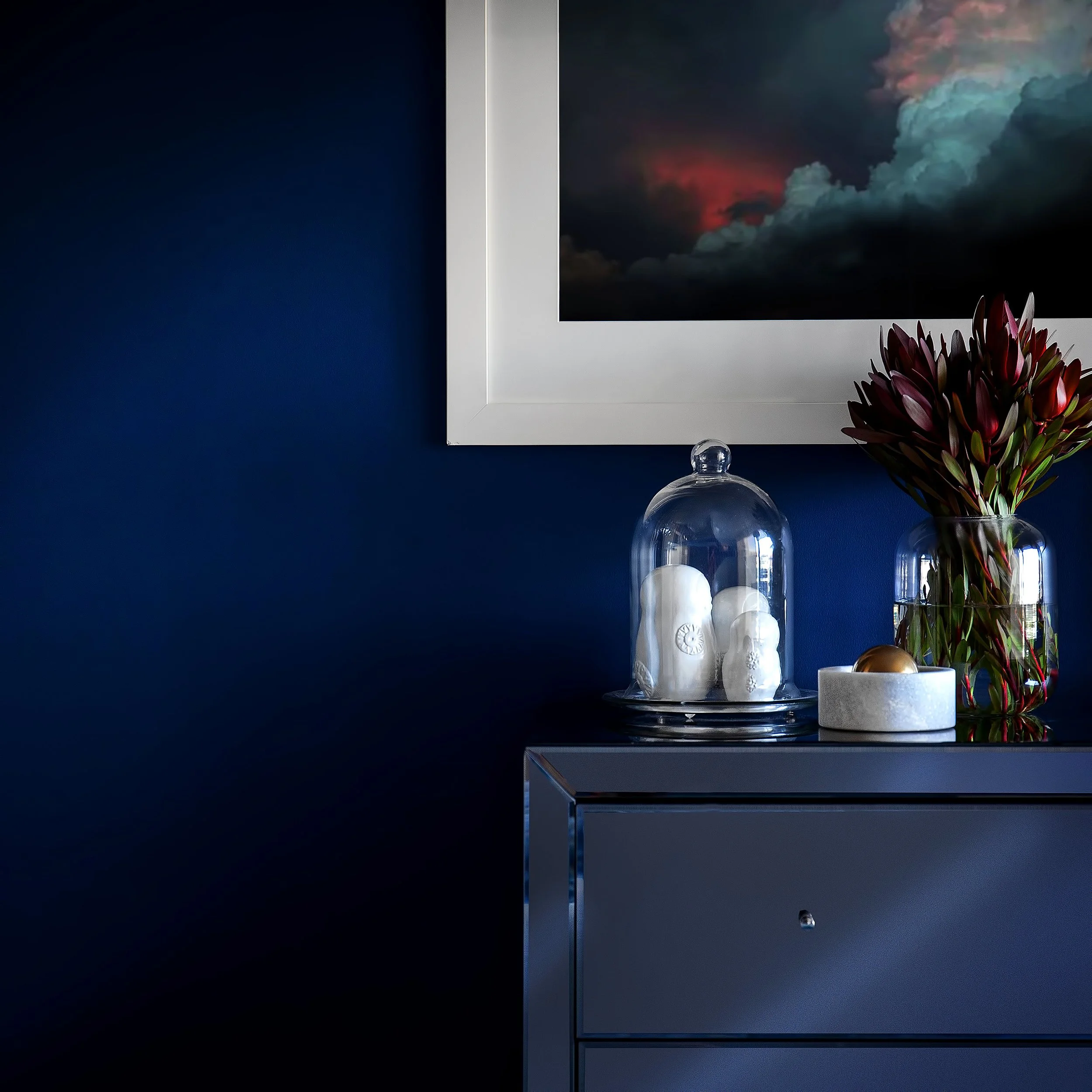 Bedroom furniture vignette with bold feature wall and curated decor