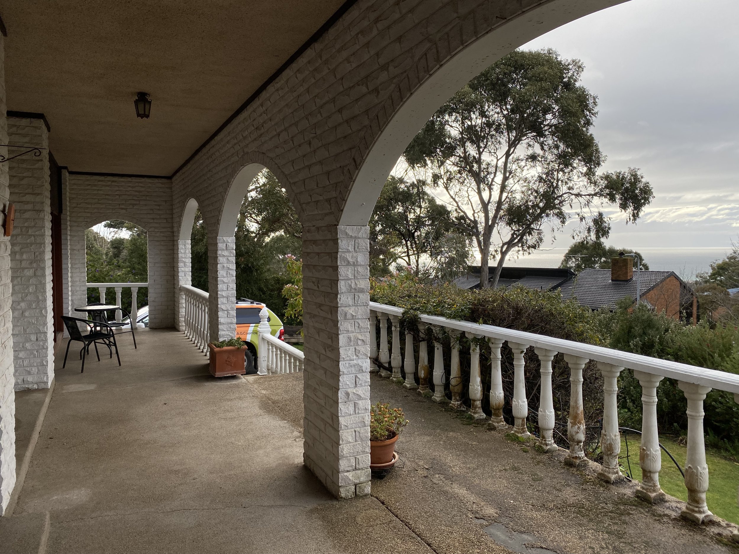 Dromana renovation before image of arched veranda with balustrade and elevated bay views