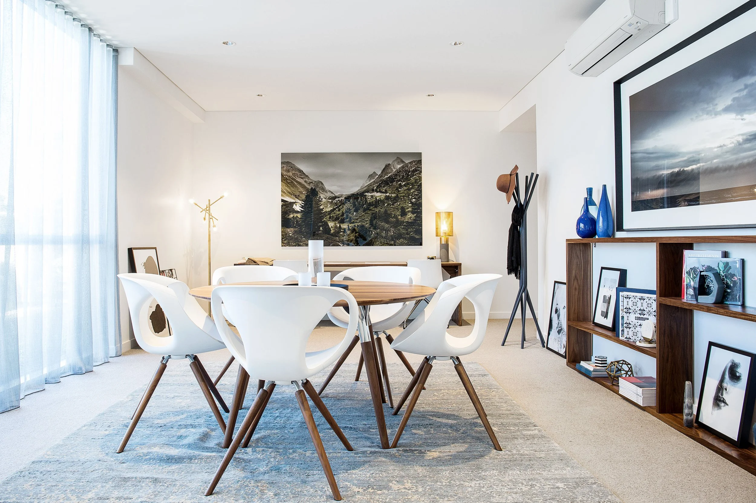 Home office styling with conference table, custom timber shelving and integrated desk in a modern residential interior