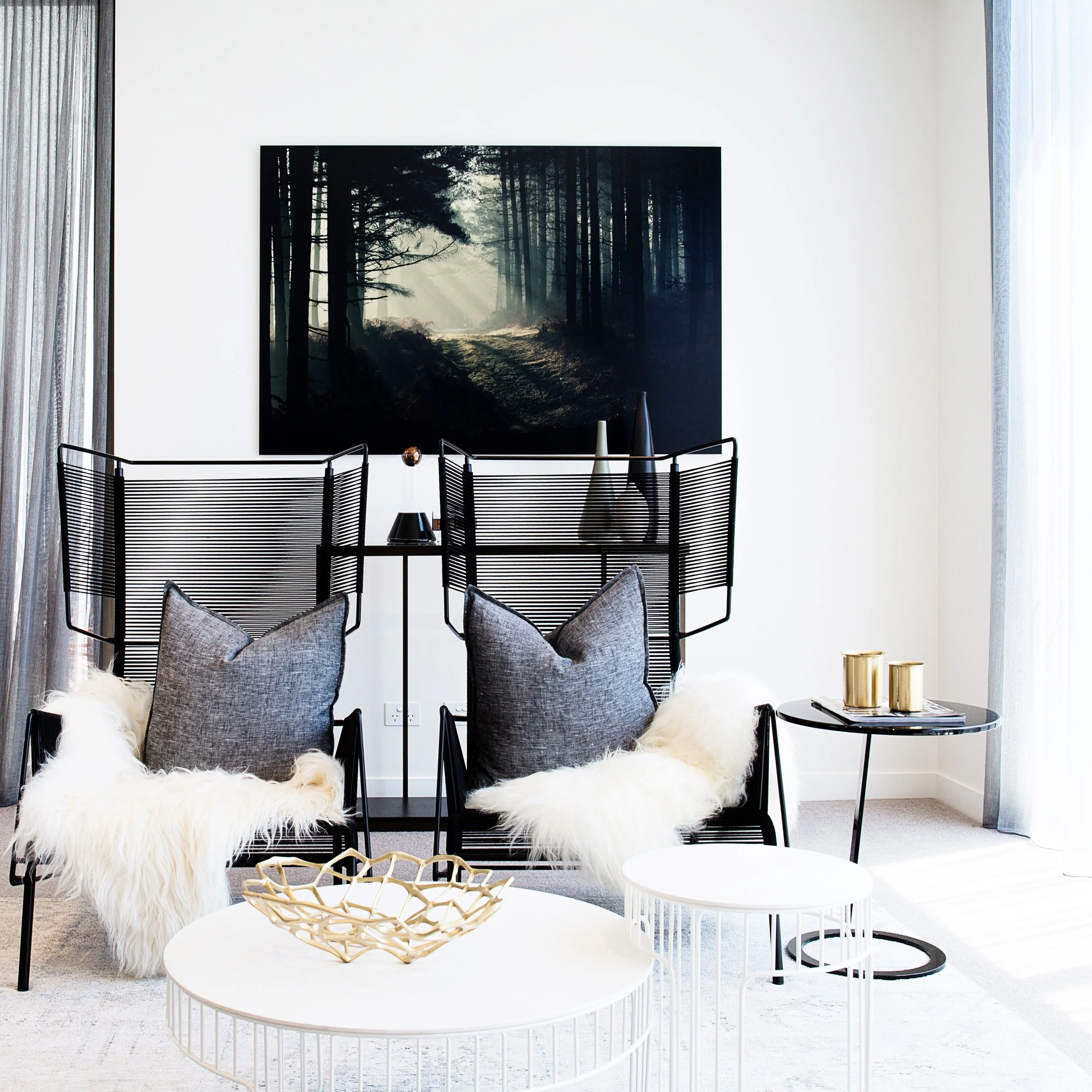 Modern open plan living space in a Docklands townhouse styled with layered textures and relaxed seating