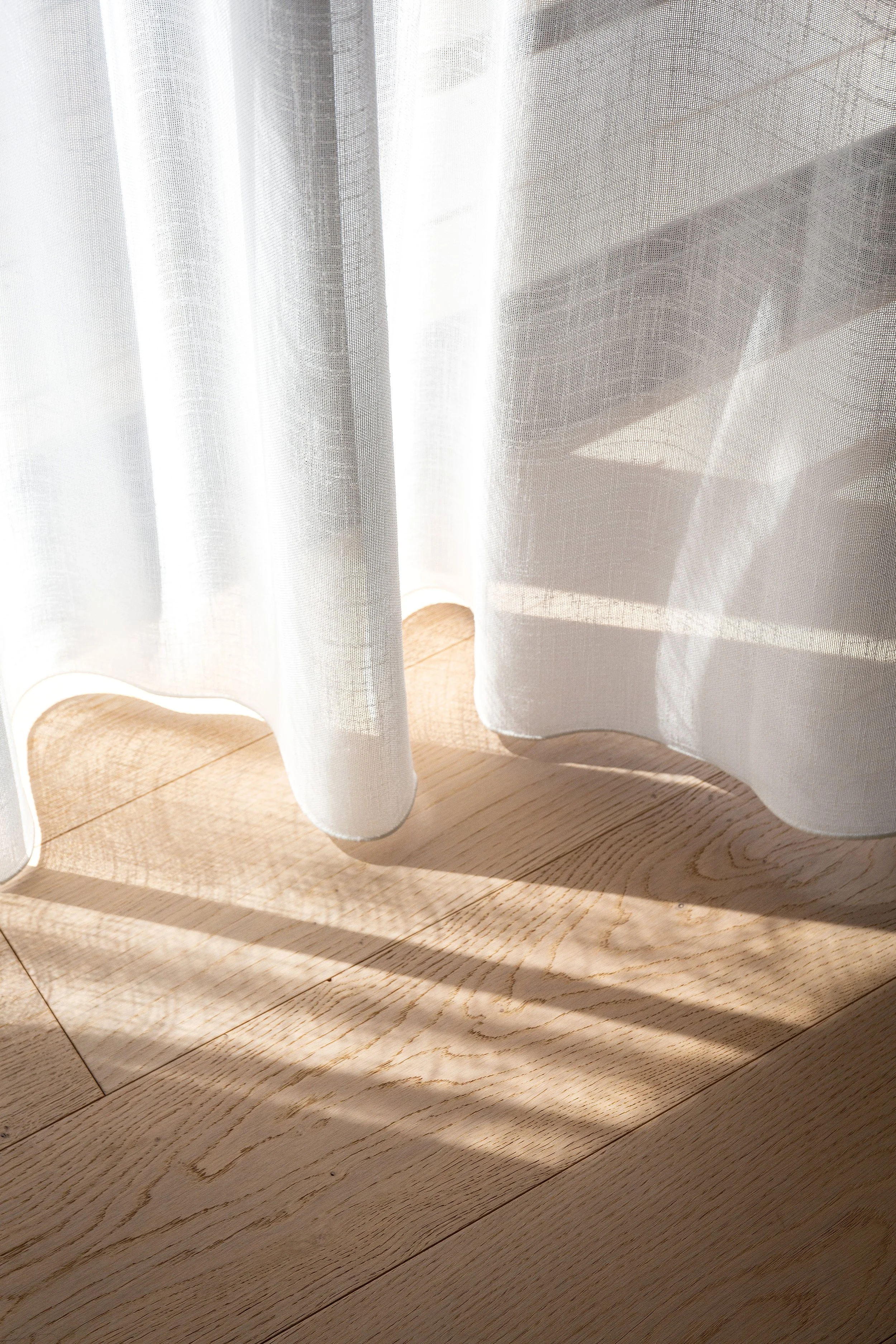 Powder room at Dromana residence with geometric terracotta and cream tiles, brass fixtures and arched mirror