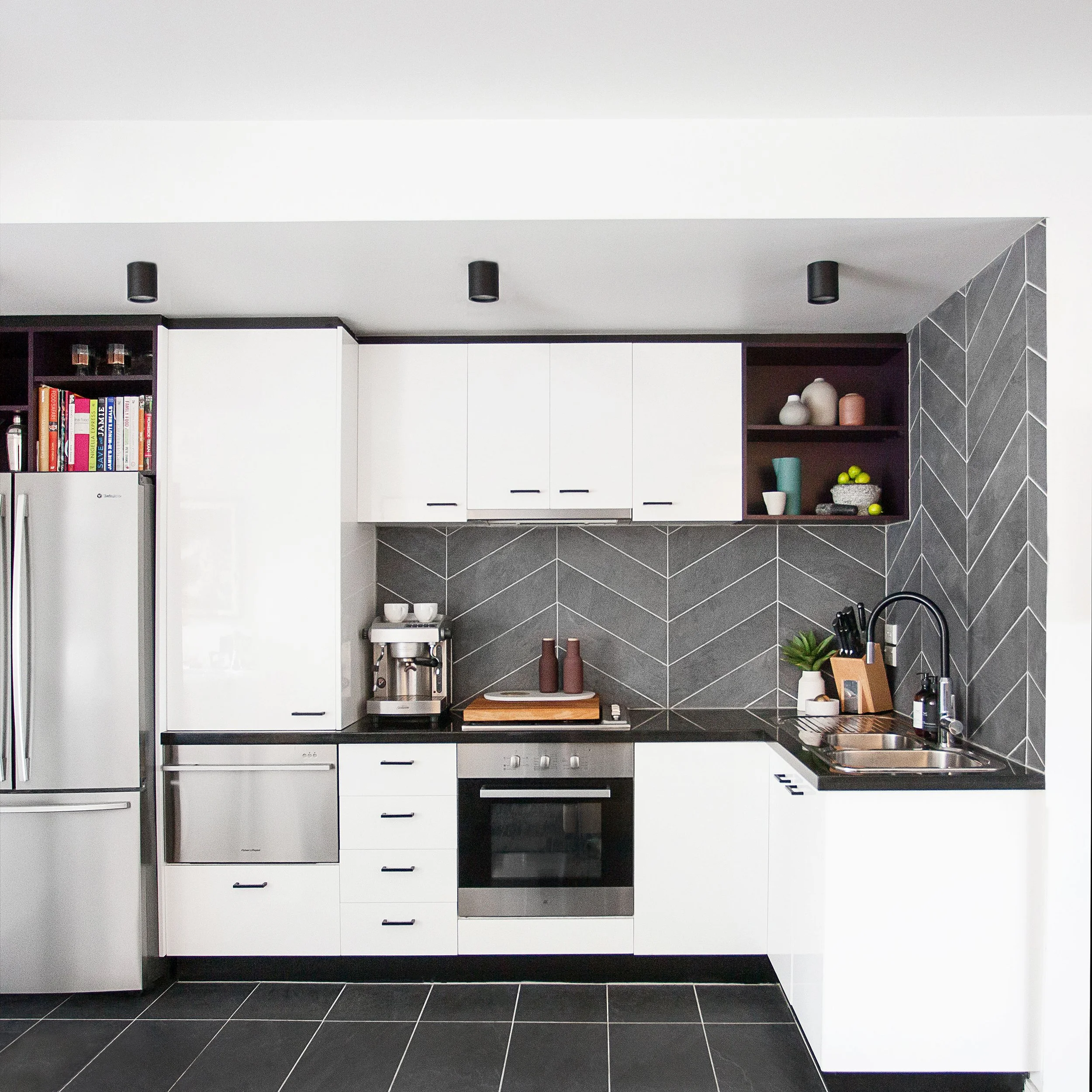 Modern kitchen with sculptural island, layered materials and contemporary finishes in Lygon Street apartment
