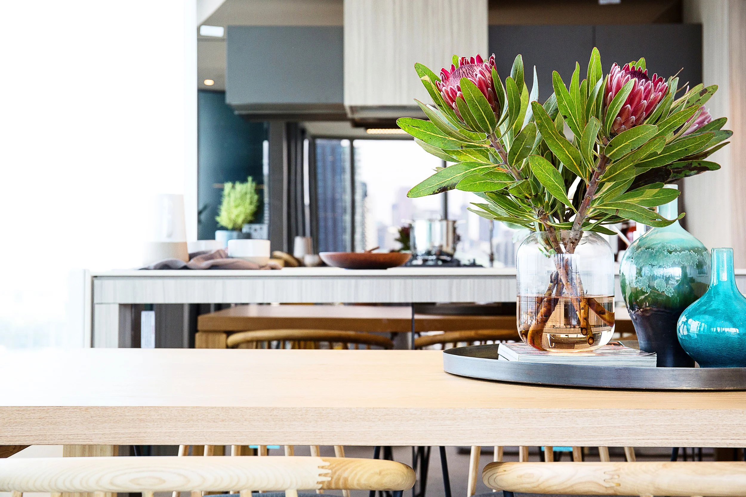 Open plan living and dining area at Forge Docklands featuring floor to ceiling glazing, Yarra River views and contemporary styling by DMP Creative.