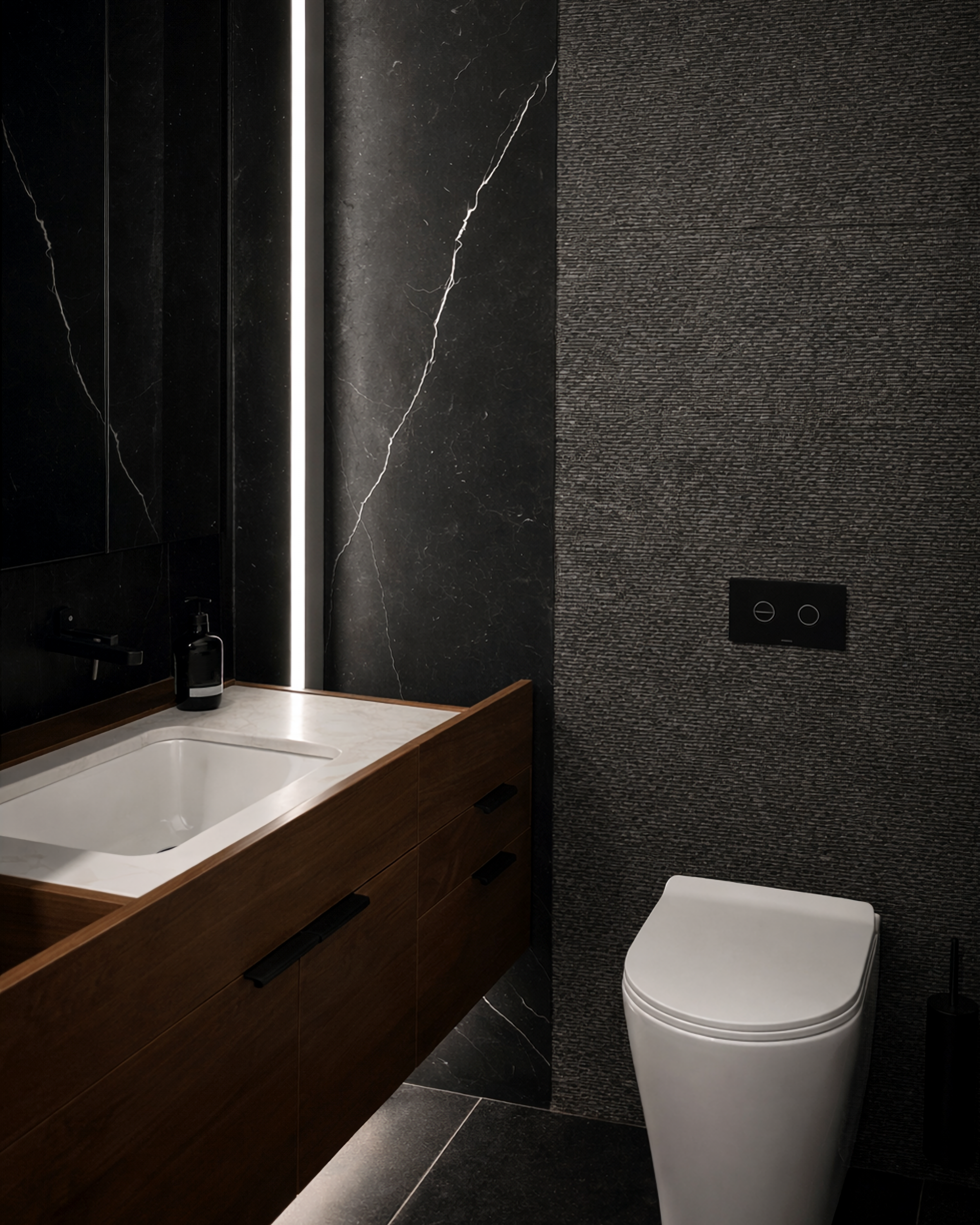 Dark stone bathroom with LED strip lighting and timber vanity