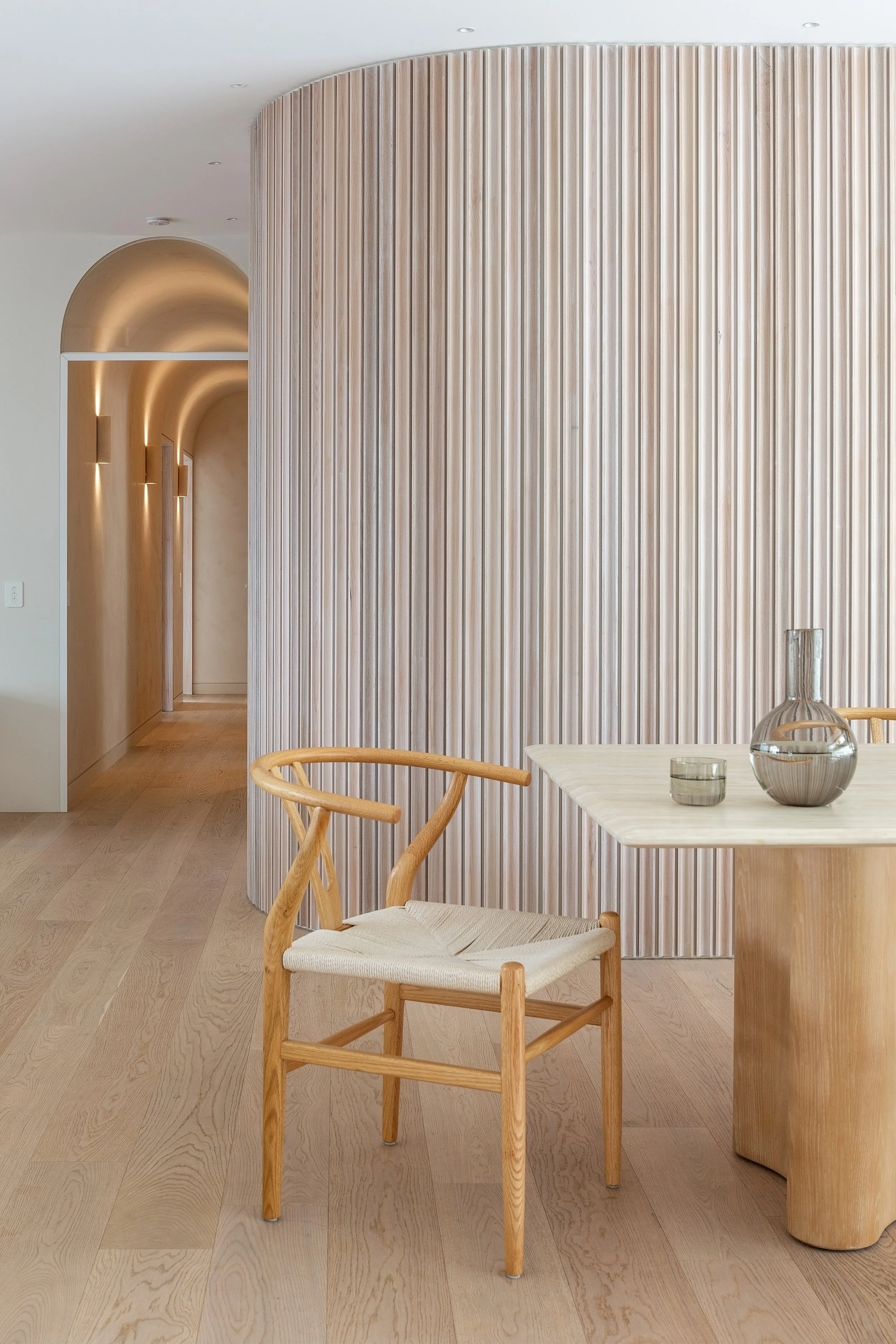 Detail of curved fluted timber wall and timber dining chair in Dromana residence