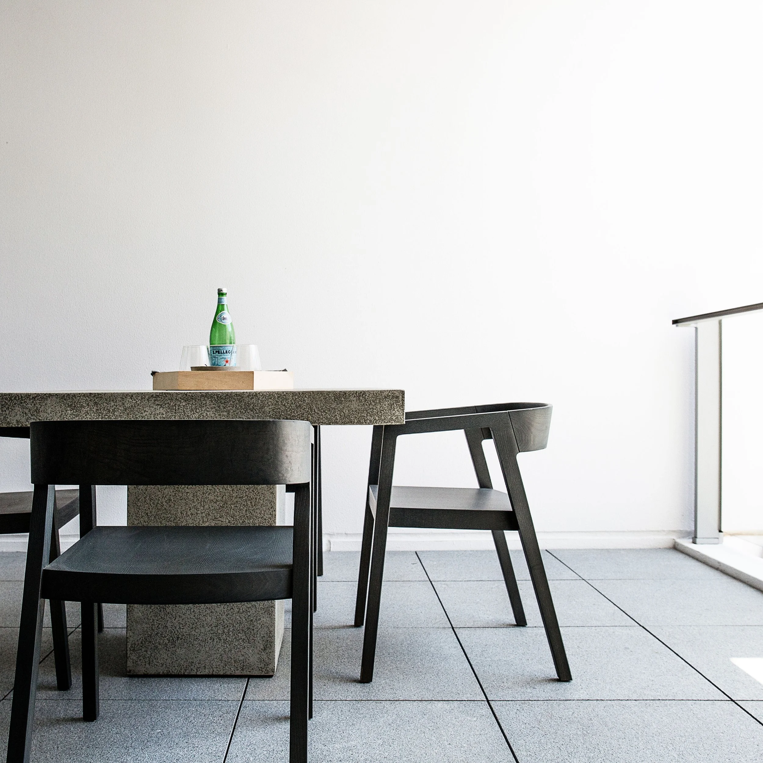 Outdoor table styling detail with minimal accessories on a modern townhouse balcony