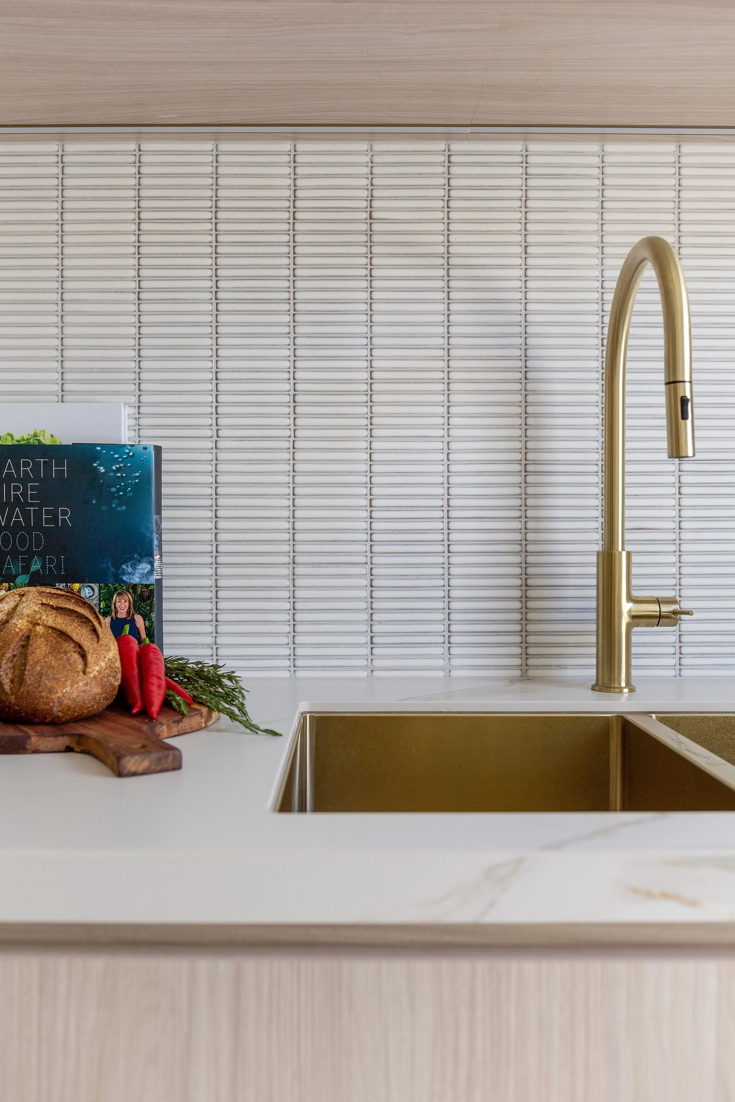 Detail of butler’s pantry splashback, brass tapware and stone benchtop at Dromana residence