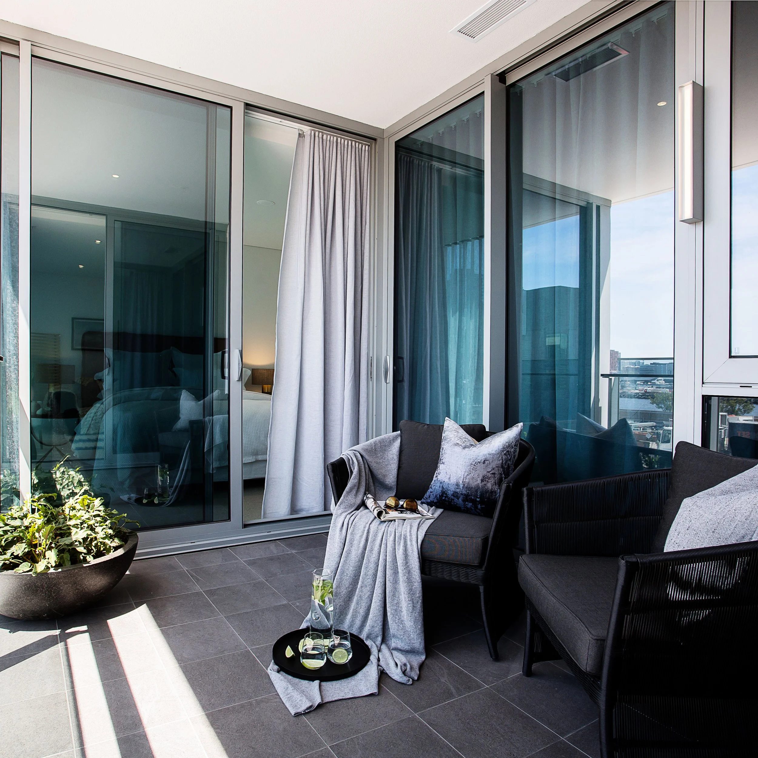 Balcony detail in Forge Docklands Apartment 204 showing glazing, city outlook and outdoor styling elements.