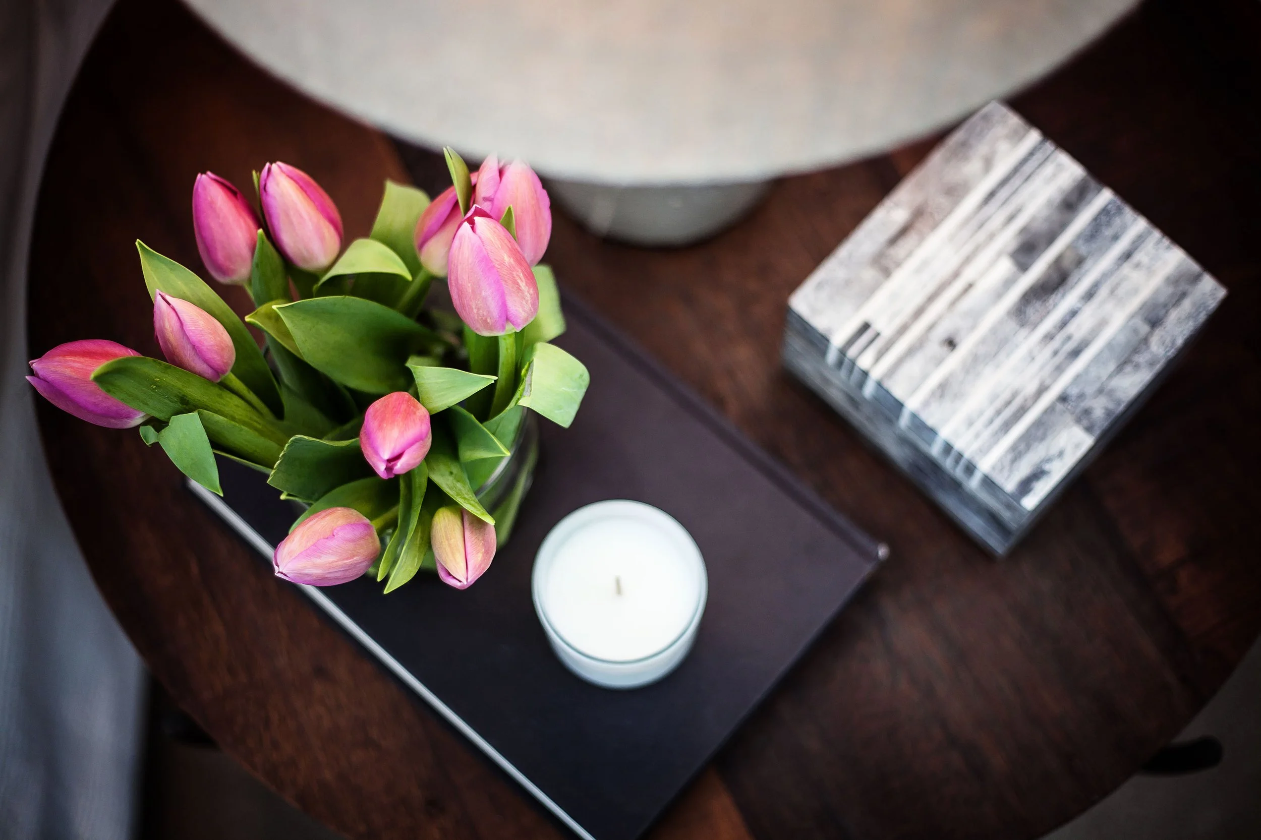 Bedside table styling detail in Forge Docklands Apartment 204 with curated accessories and tulips.
