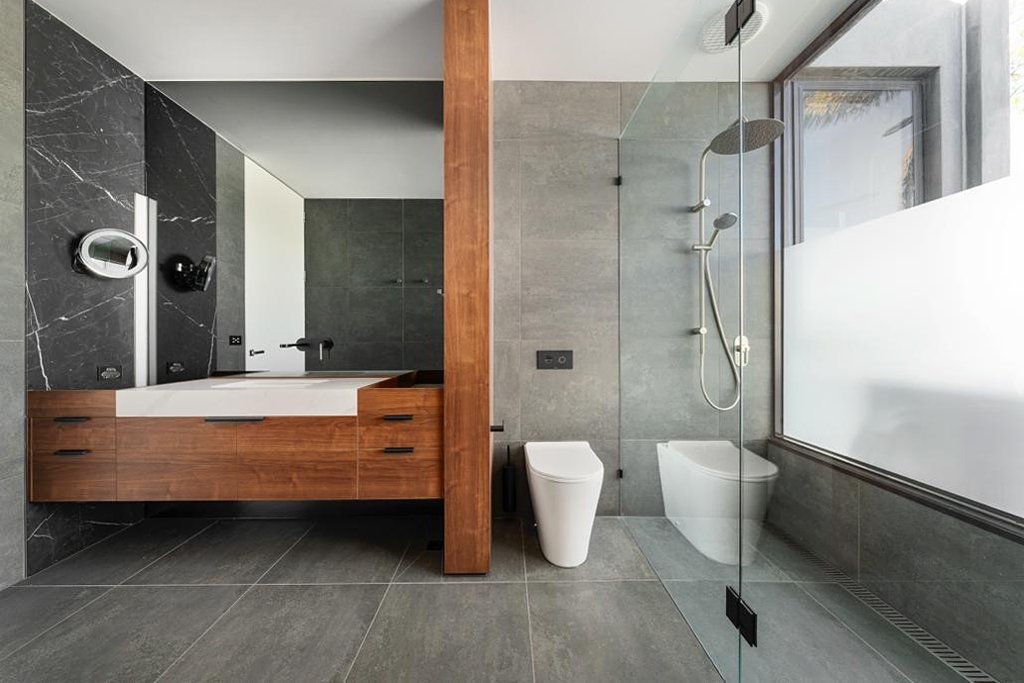 Floating timber vanity with stone top in modern bathroom