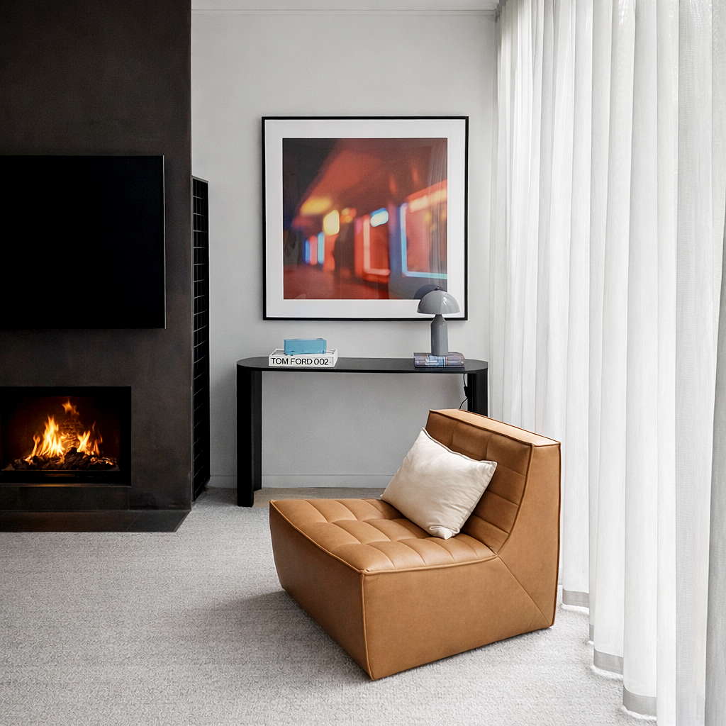 Contemporary lounge with gas fireplace and leather chair